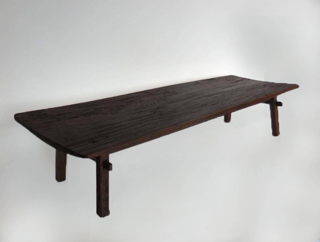 19th century beautiful, dark, rich chocolate color wood antique bed from Nepal. One wide board, stretchers. Great simple, yet modern design. Mortise and tenon construction. Smooth, worn patina throughout. Can be used as a coffee table or bench.
