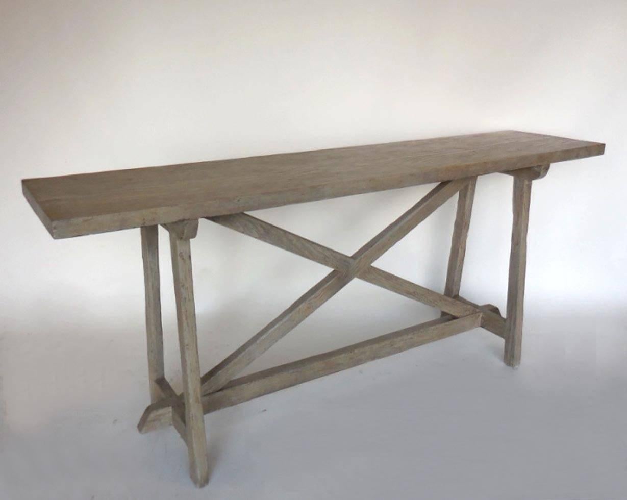 Weathered, driftwood finish console in reclaimed douglas fir with X stretcher with a hand-forged iron mariposa (butterfly). Can be made custom in any size and in a variety of finishes. Made in Los Angeles by Dos Gallos Studio.
PRICES ARE SUBJECT TO
