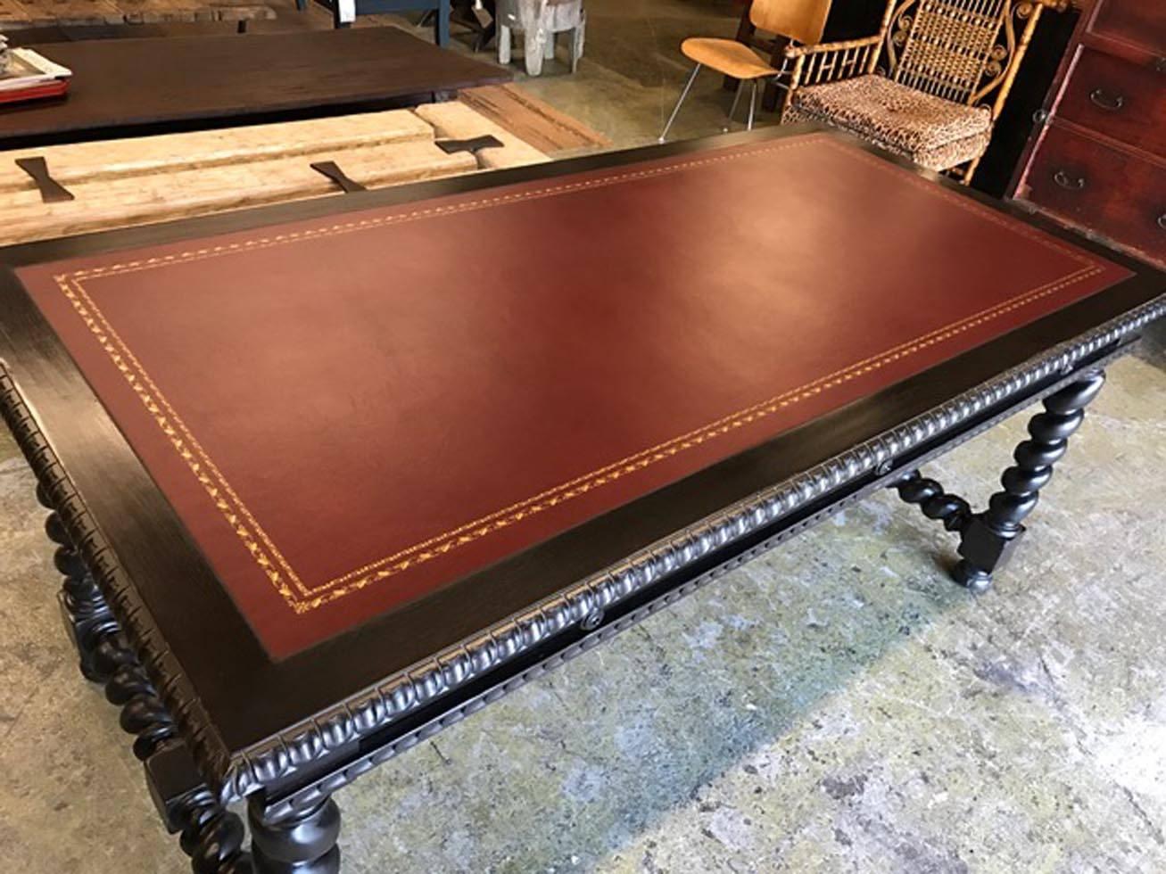 Walnut desk with barley twist legs and carving around edge of table and apron. This one was made with three pencil drawers and a double gold embossed leather insert. Dark walnut finish, medium distress. Can be made in any size and finish, with or