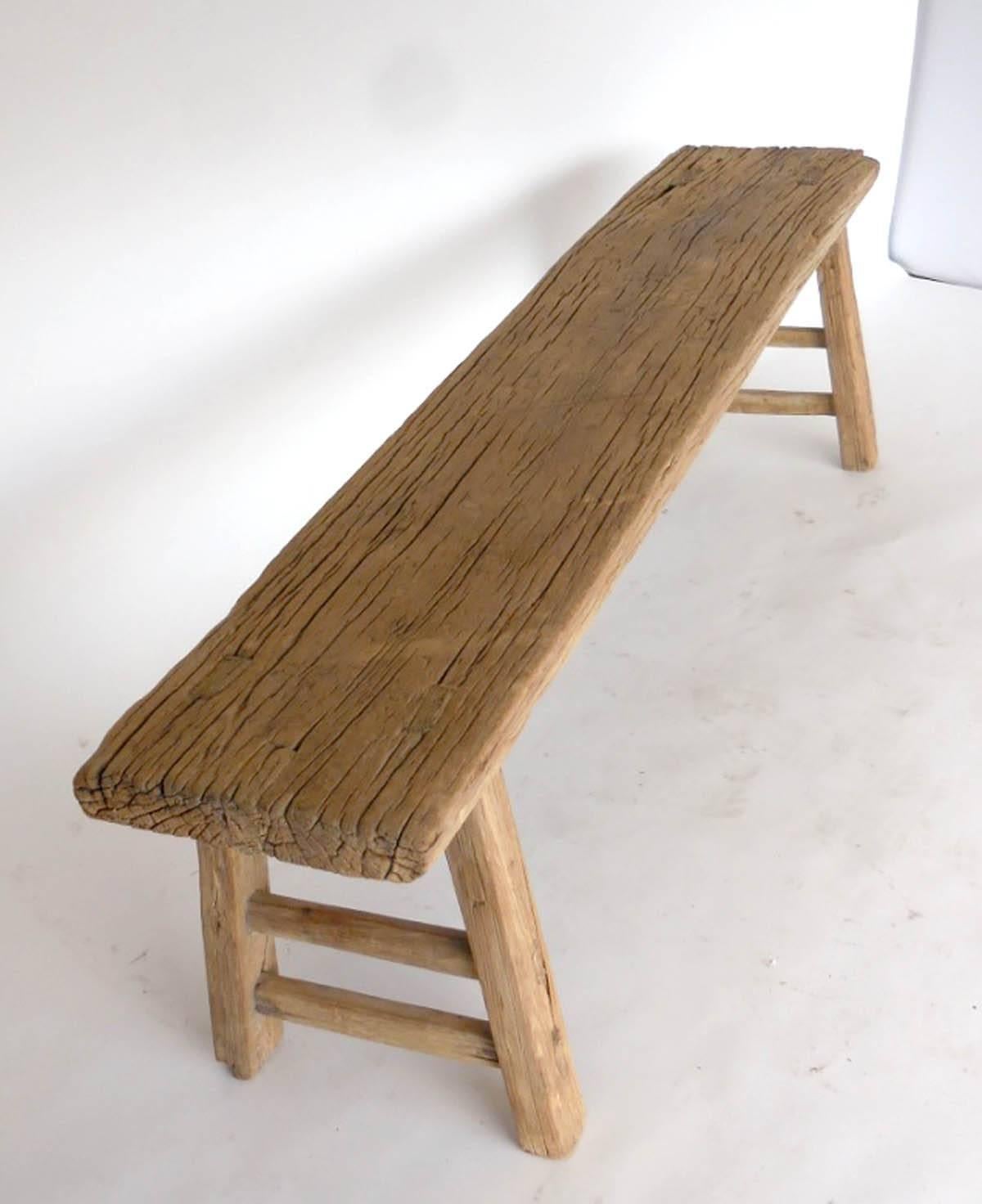 19th century Chinese elmwood bench from one plank, double short stretchers. Beautiful smooth natural patina. Sturdy and functional.