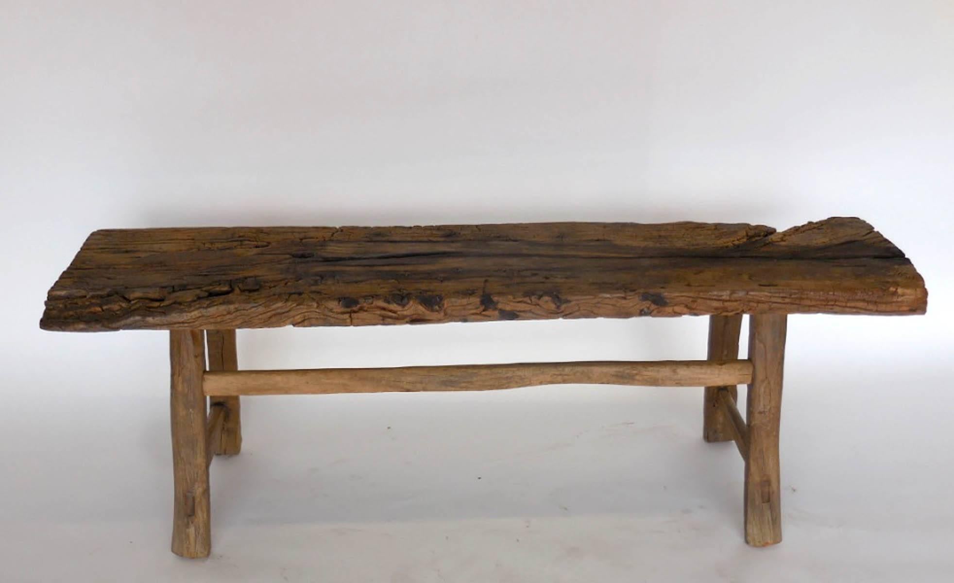 Early 19th century Chinese Chestnut bench with wonderful old wood and branch stretcher. Sturdy and functional. Mortise and tenon construction.