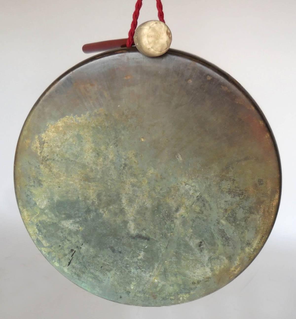 Unusual Late 19th Century to Early 20th Century flat Japanese bronze gong with leather striker. Lovely patina throughout! Nice resonance. The flat surface give it a modern appearance though it is antique.