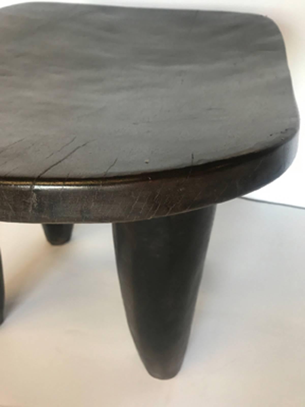 1950s hand-carved wooden stool or side table made by the Sinufo tribe in Mali. Iroko wood. Smooth patina. Age appropriate wear. We have a second similar available, as pictured.

 