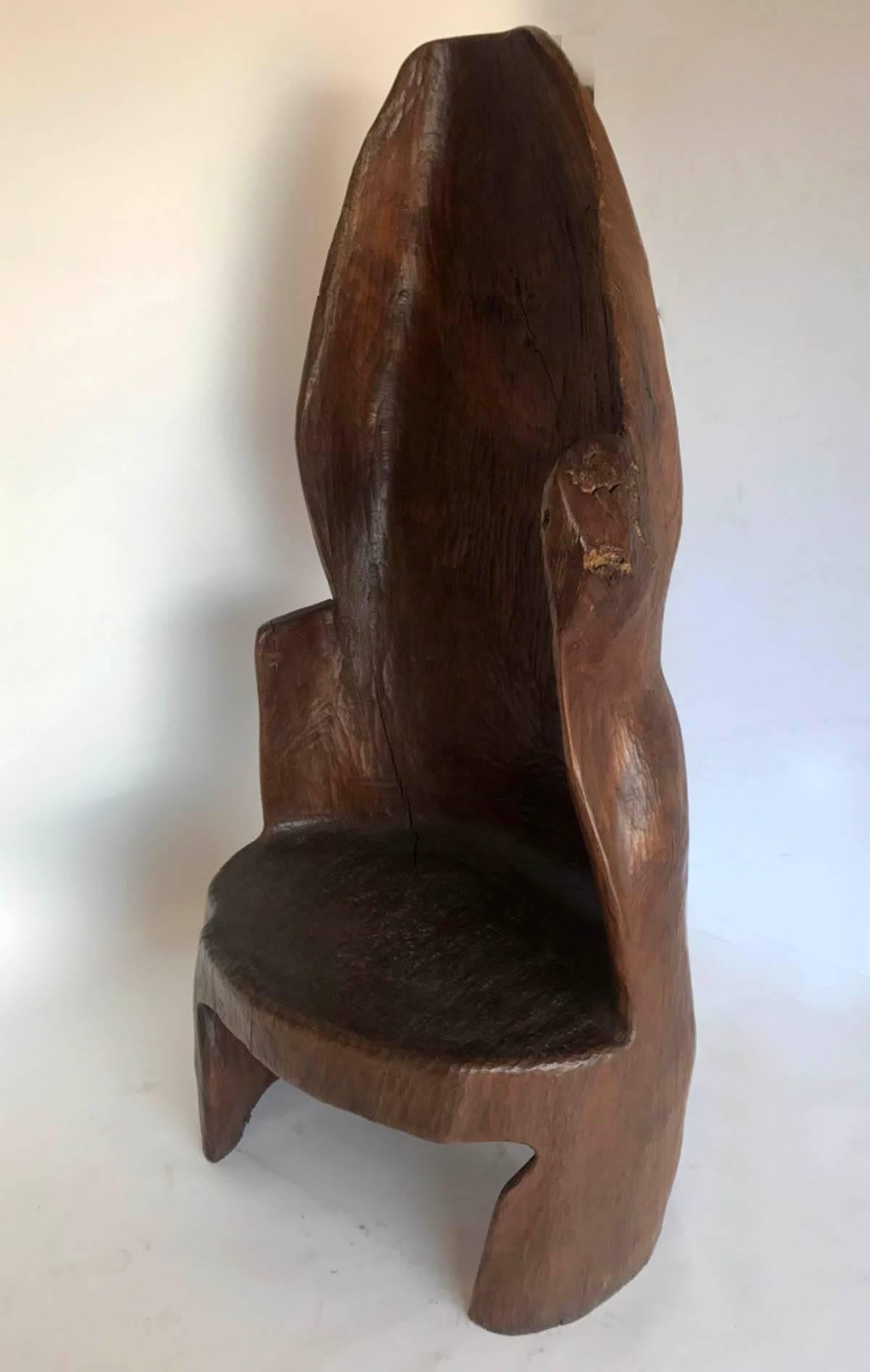 Sitting in this chair is like being inside a cocoon. It's large and surrounds you. The carver had a sense of humor when carving the back, see photo!
nice, smooth patina throughout, some natural cracking but doesn't interfere with sturdiness. Carved