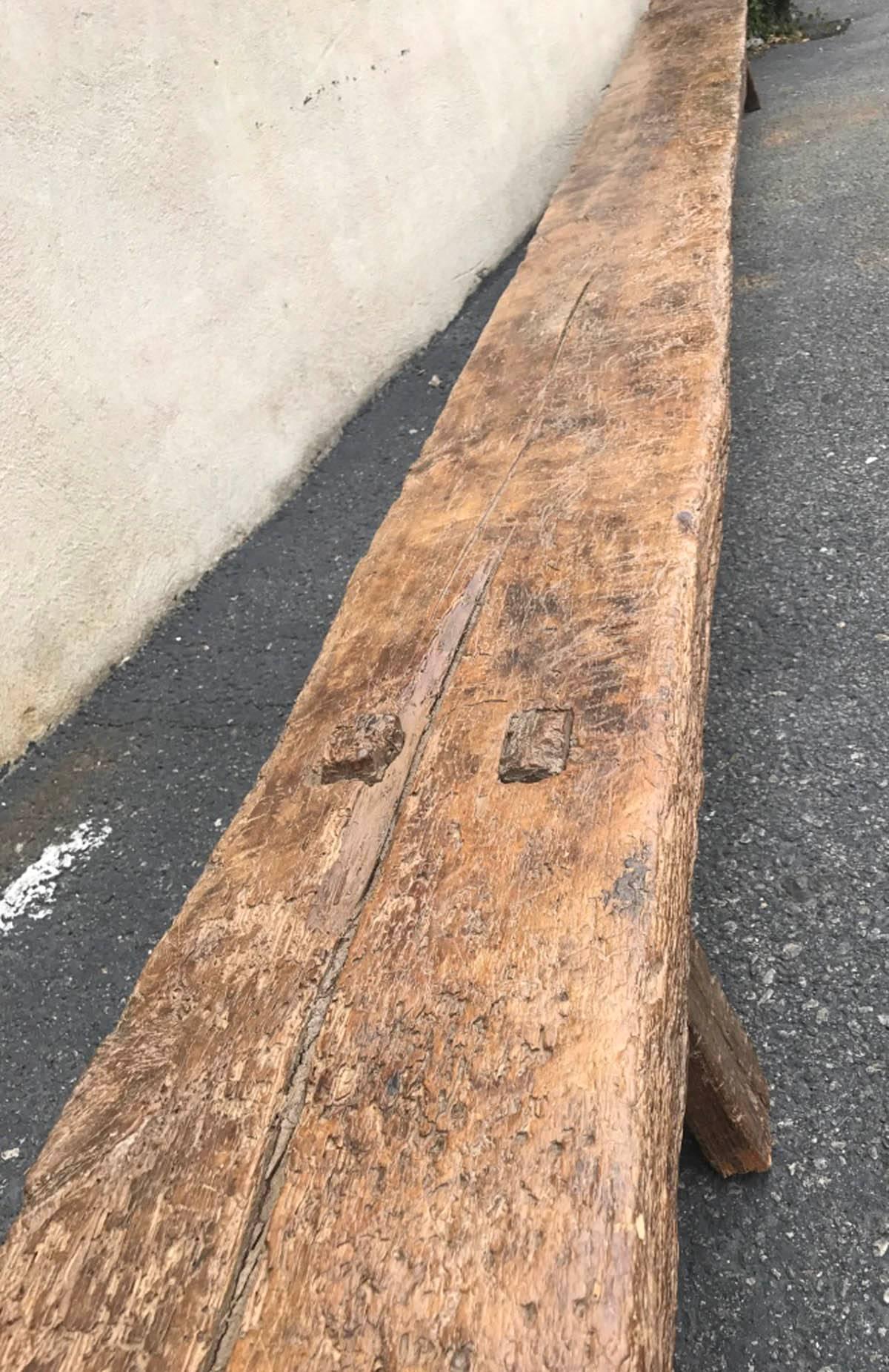 19th century low bench. One very long, 4 inch thick piece of wood with straight mortise and tenon constructed legs. Old, natural patina. Sturdy, with cracks and age appropriate wear.
Very Primitive modern. Very Axel Vervoordt.
