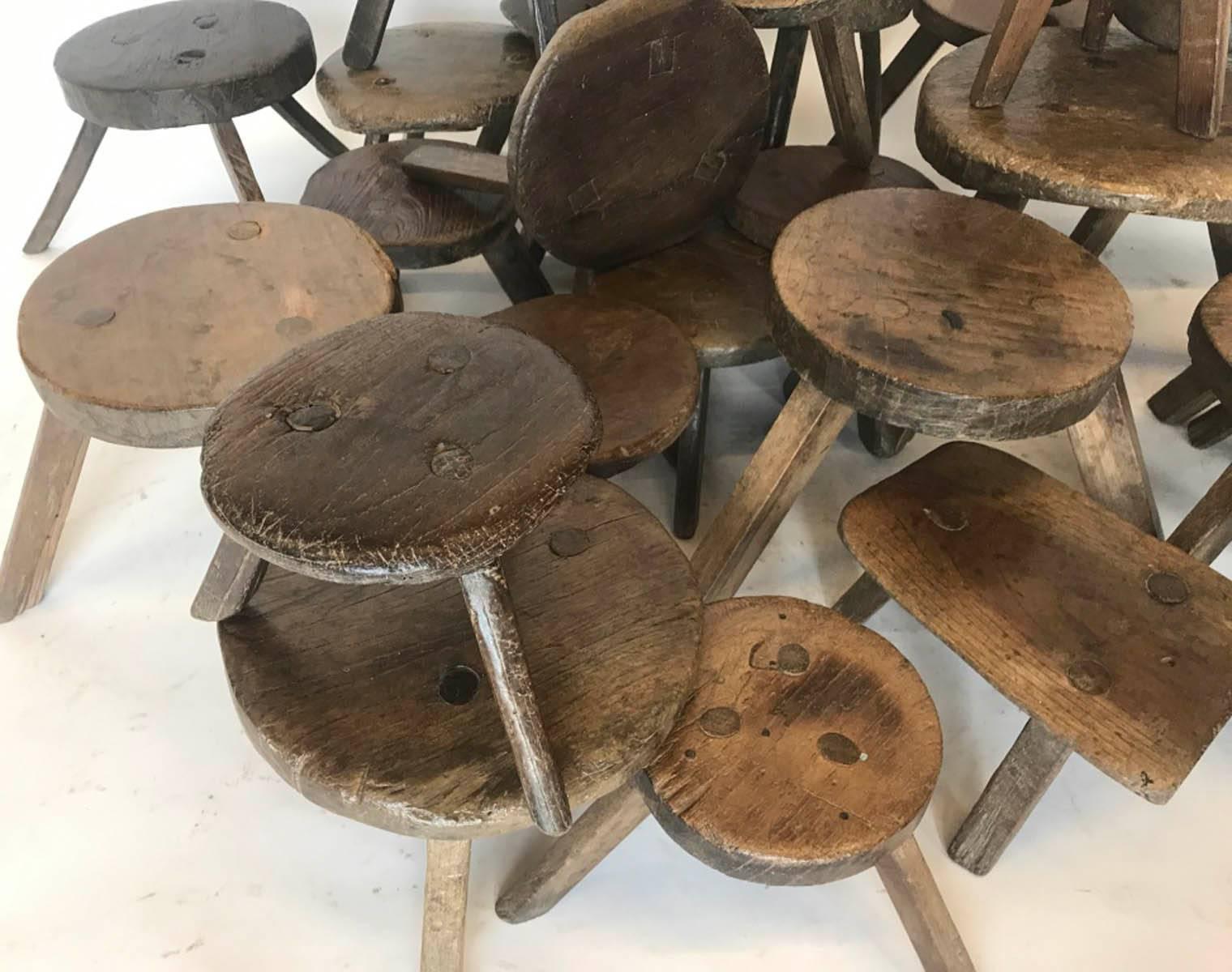 A collection of antique, 19th century wooden milking stools in various sizes. Price varies, from $255 - 550 each. Approximate sizes are 9 D x 7 H to 13 D x 10 H. Smooth, naturally worn patina on all of them. Three legs.