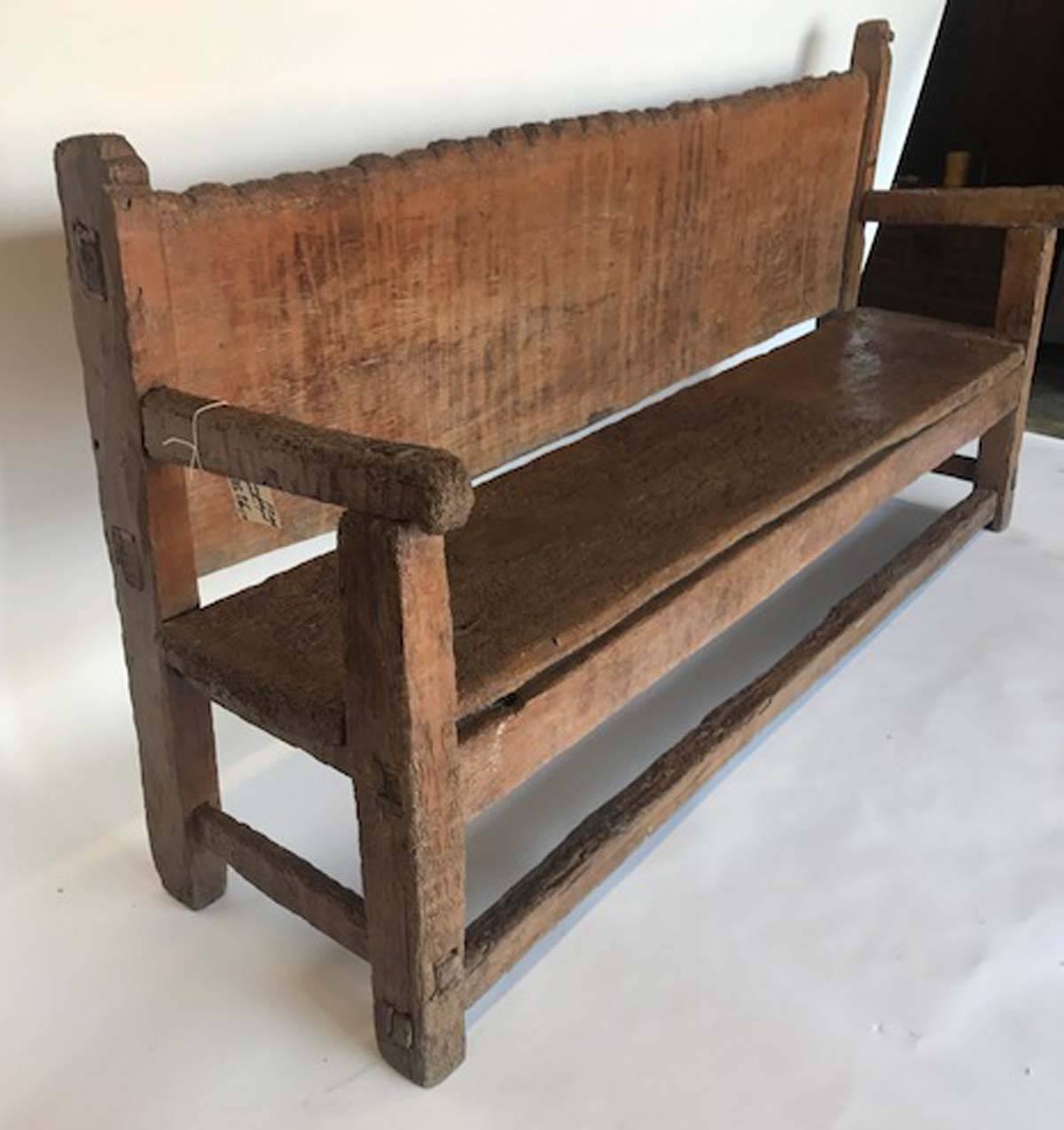 Rustic and Primitive Chajul bench from Guatemala. Back and seat consists of one wide board, hand hewn. Mortise and tenon construction and carved back. Old but sturdy!