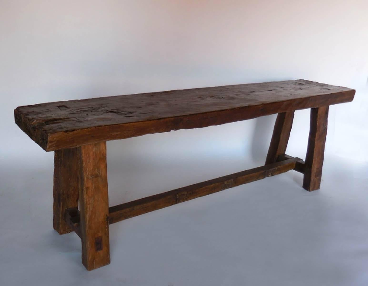 Console with thick straight legs and a 3.5 inch thick cipres wood top. Originally used as a table in a cofradia (Guatemalan indigenous holy house). Beautiful rich honey brown patina with some old burn marks. Primitive and rustic. Stretcher is in the