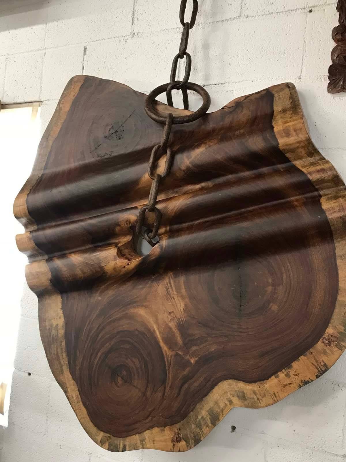 Beautiful free-form, organic shaped piece of concaste wood with vintage marine chain.
Wood has been hand-carved by master carvers, to look like a rolled out bolt of fabric. It undulates. Wood is two inches thick and undulates so the overall