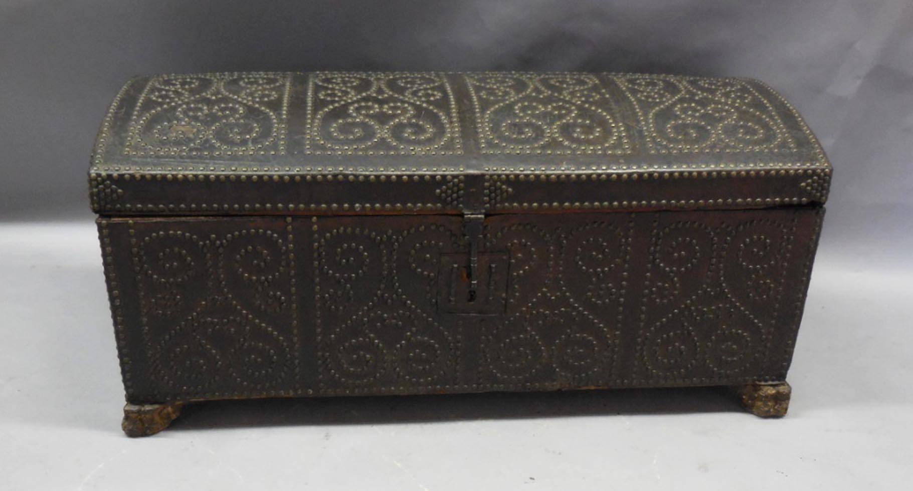 Domed leather coffer with brass studs, patterned in four quadrangles. Carved feet. All original hardware and in good condition considering its age. Some areas of leather are deteriorated but not interfering with form or function, 18th century