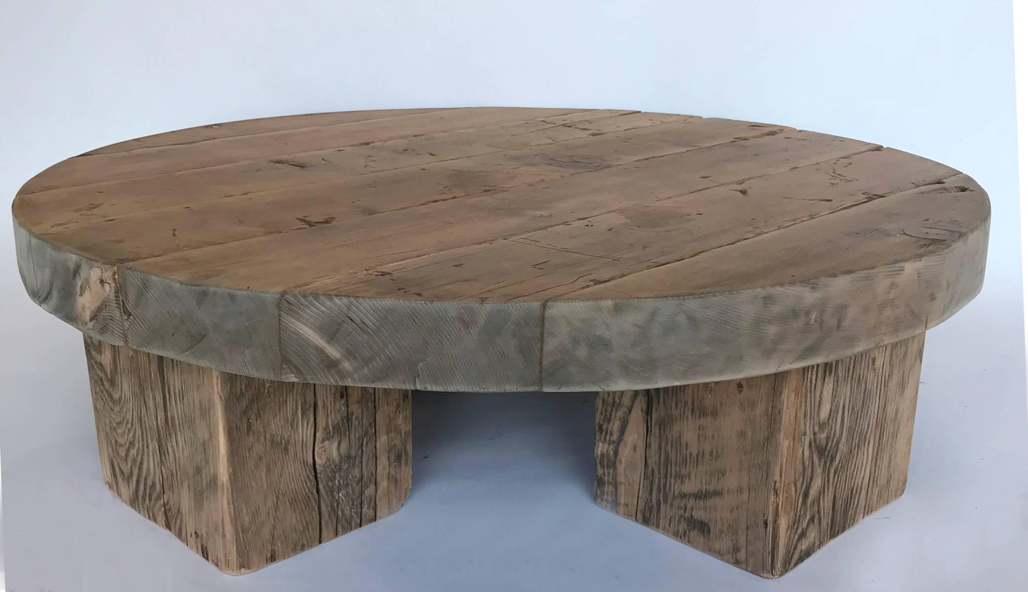 Three and a half inch thick 100 year old reclaimed wood boards make up this low rustic modern coffee table with four solid thick legs. Natural finish. Smooth to the touch.