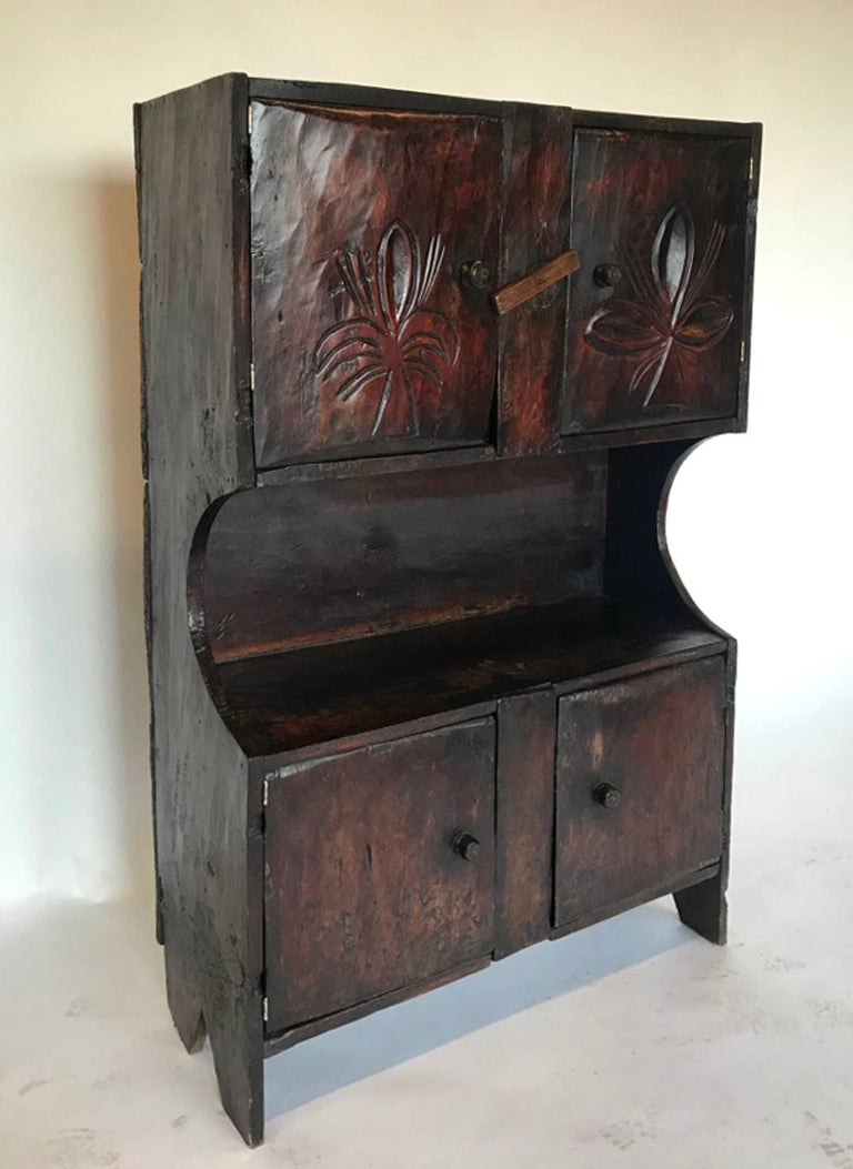 Small scale cabinet from the highlands of Guatemala. Originally used as a trastero kitchen storage for crockery.
Beautiful, old dark patina with carving on the doors. Upper portion has an interior shelf. Rustic latch. Perfect for a small space or in