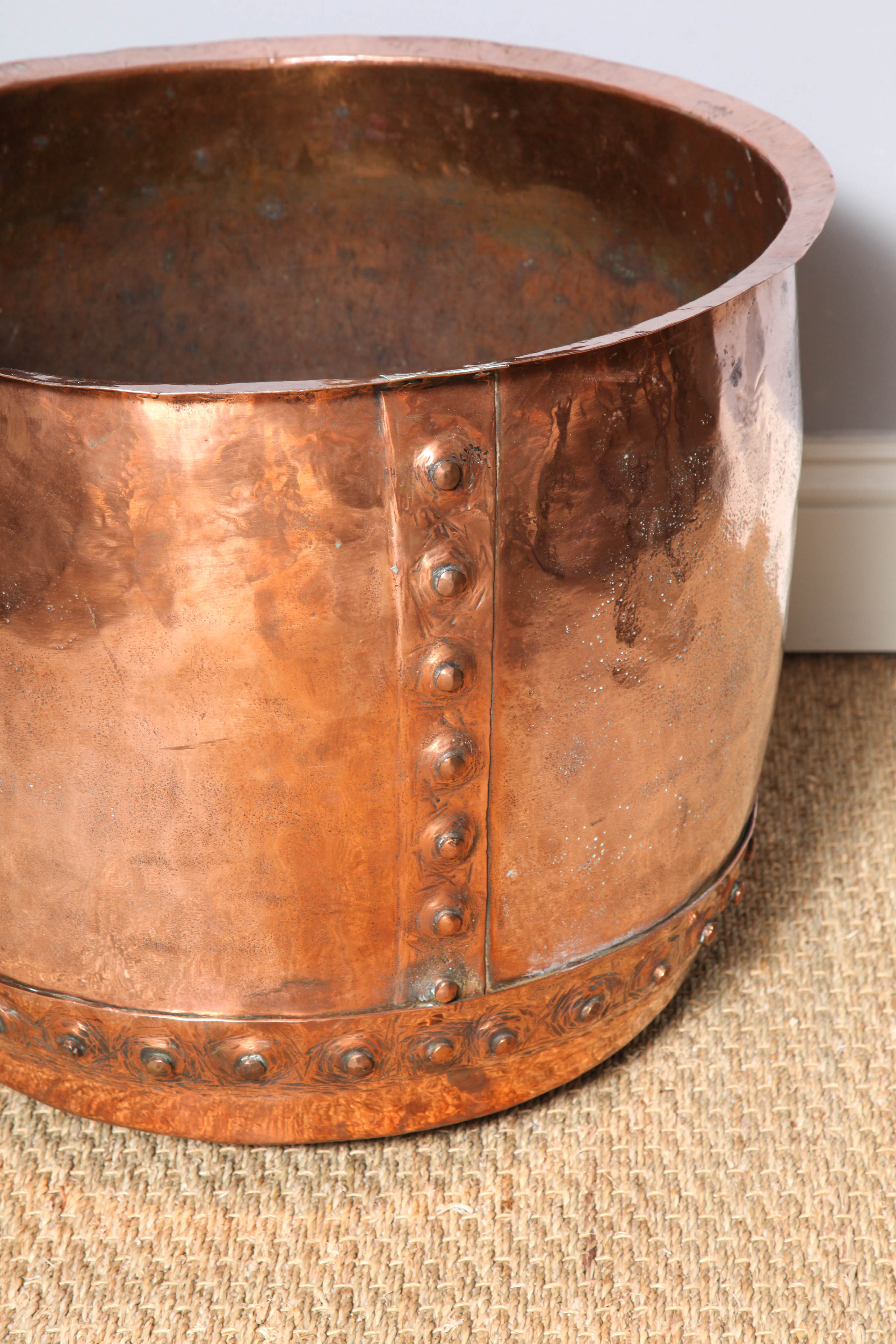 Very good early 19th century English hand riveted copper pot, having flared rim, beaten sides, the nippled rivets with octagonal borders, the copper mellowed to a rosy color.
      
   