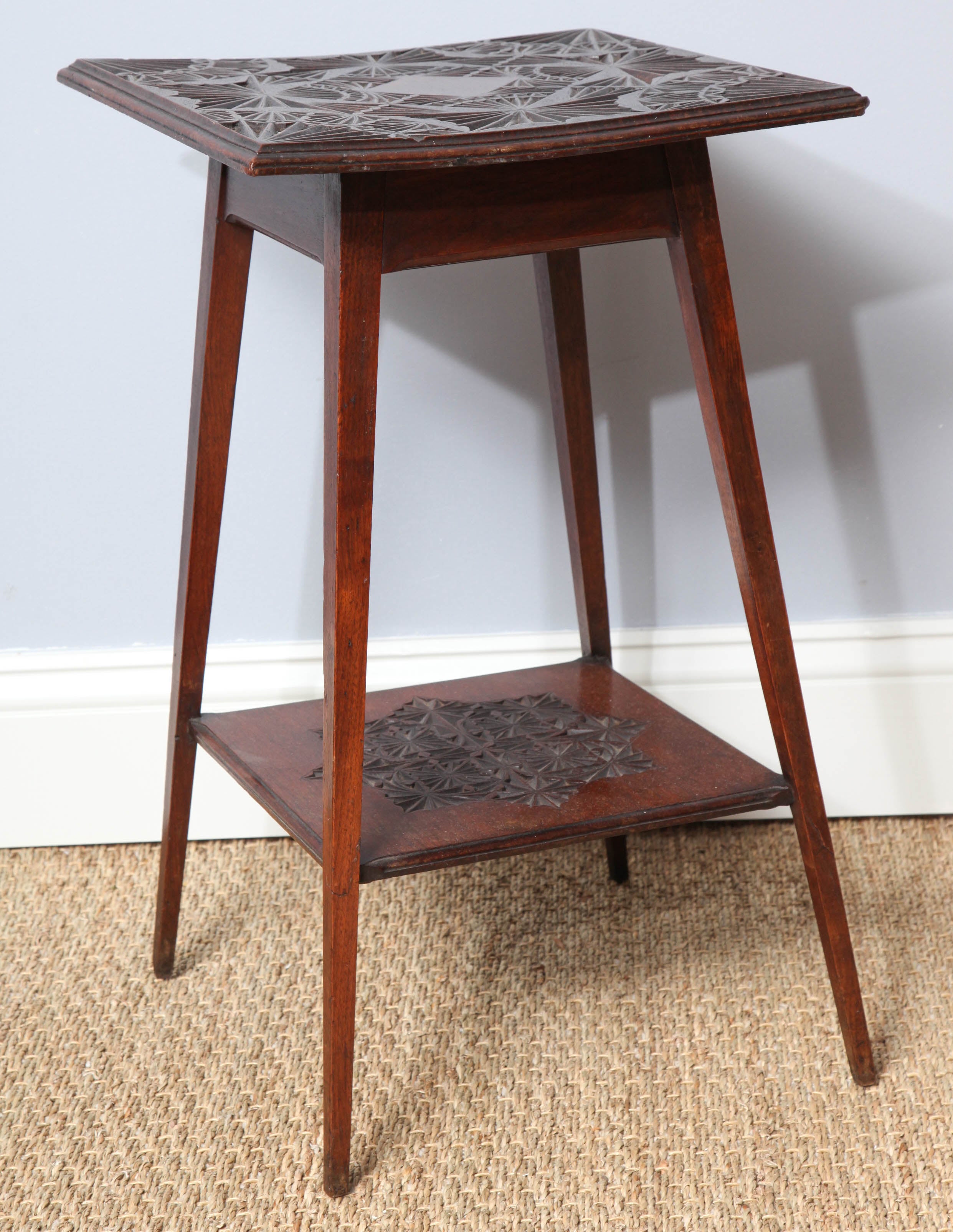 Finely chip-carved late 19th century Anglo-Indian table in the Aesthetic taste, with fine geometric patterned carving to the top and shelf, on square tapered and flared legs, the whole with pleasing color and good form.