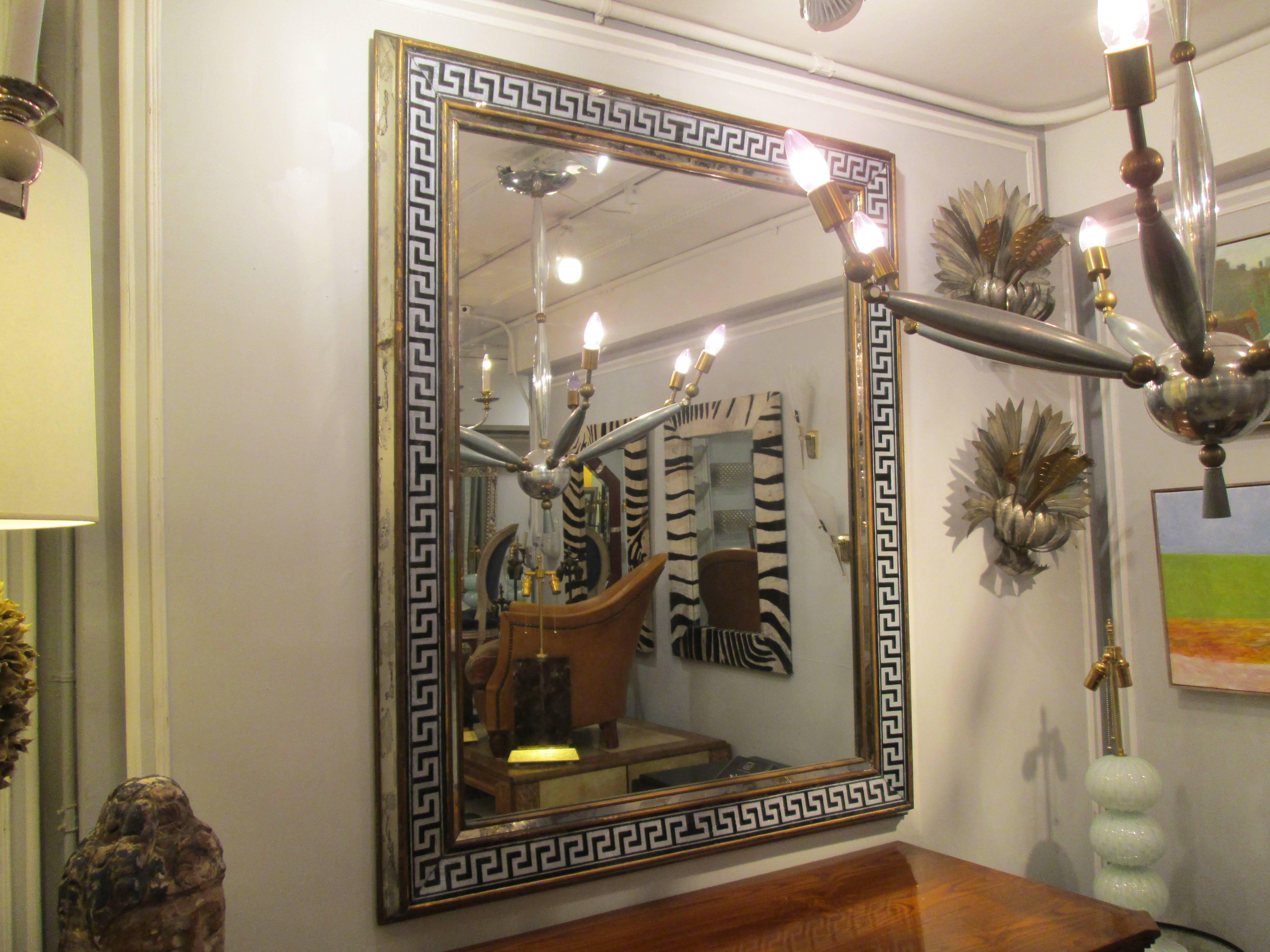 Reverse-painted rectangular mirror with Greek key pattern.