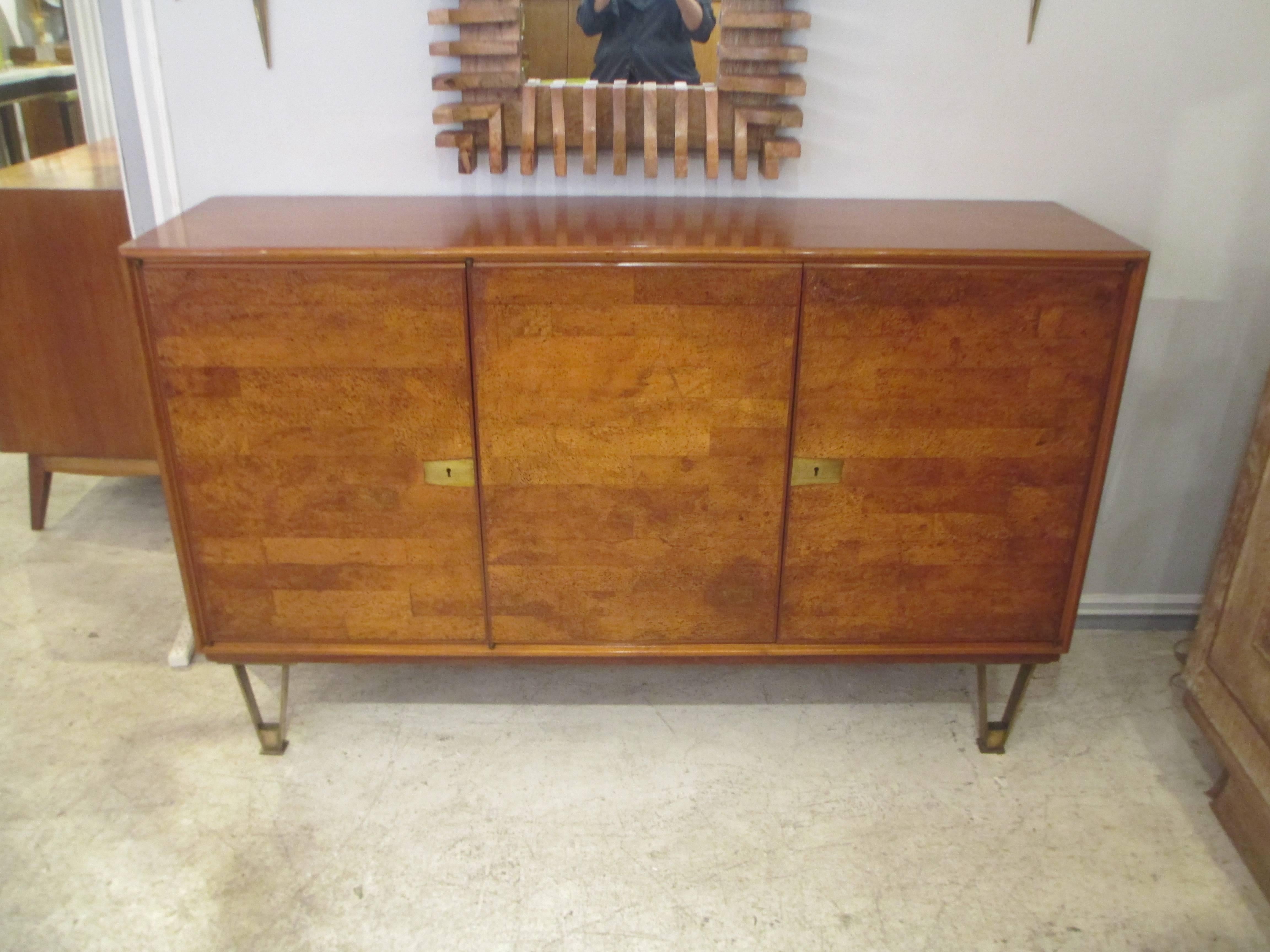 Rare Mid-Century cork sideboard with three-drawer supported on tapered bronze legs.