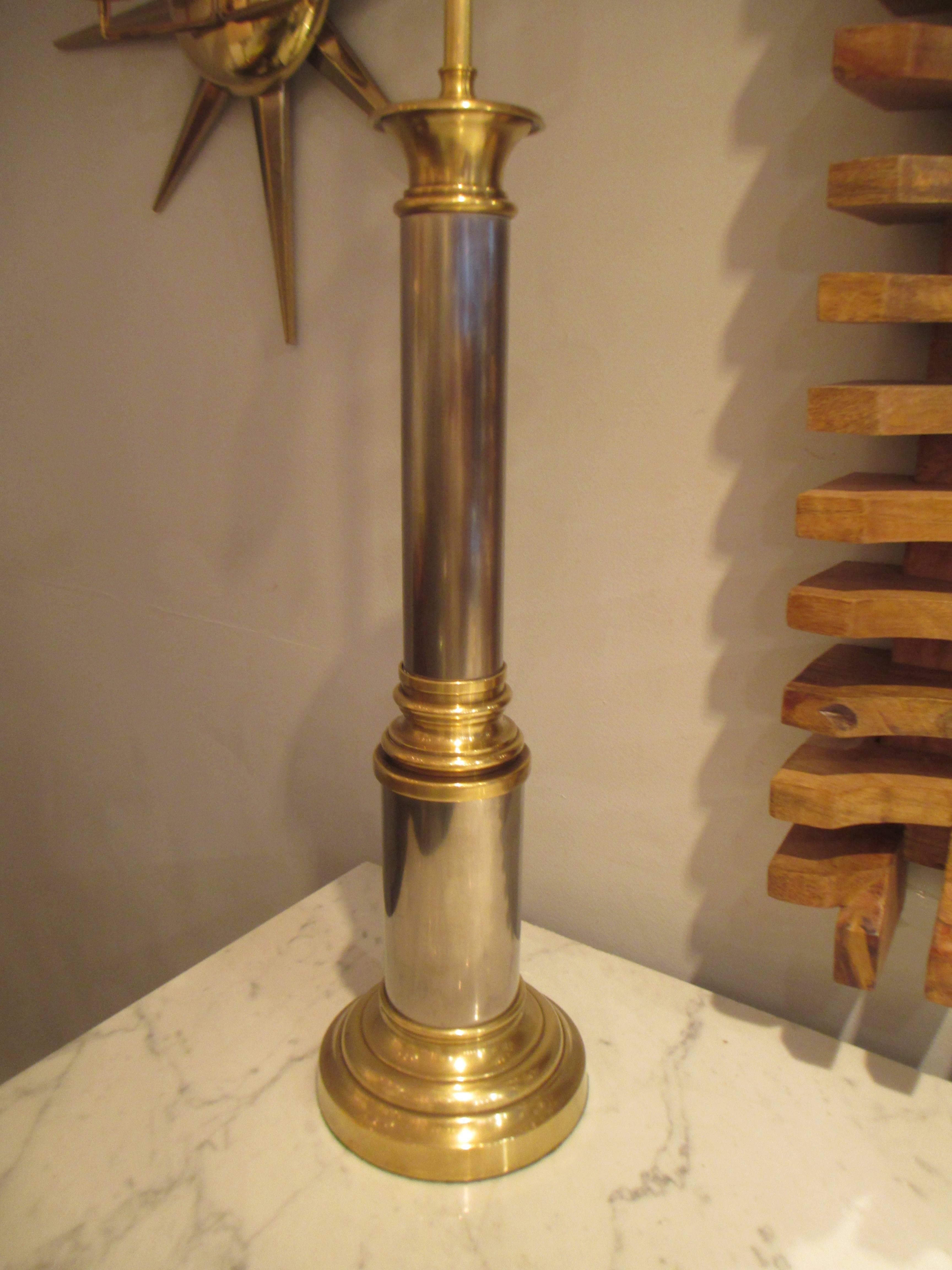A pair of brass and chrome column lamps.
