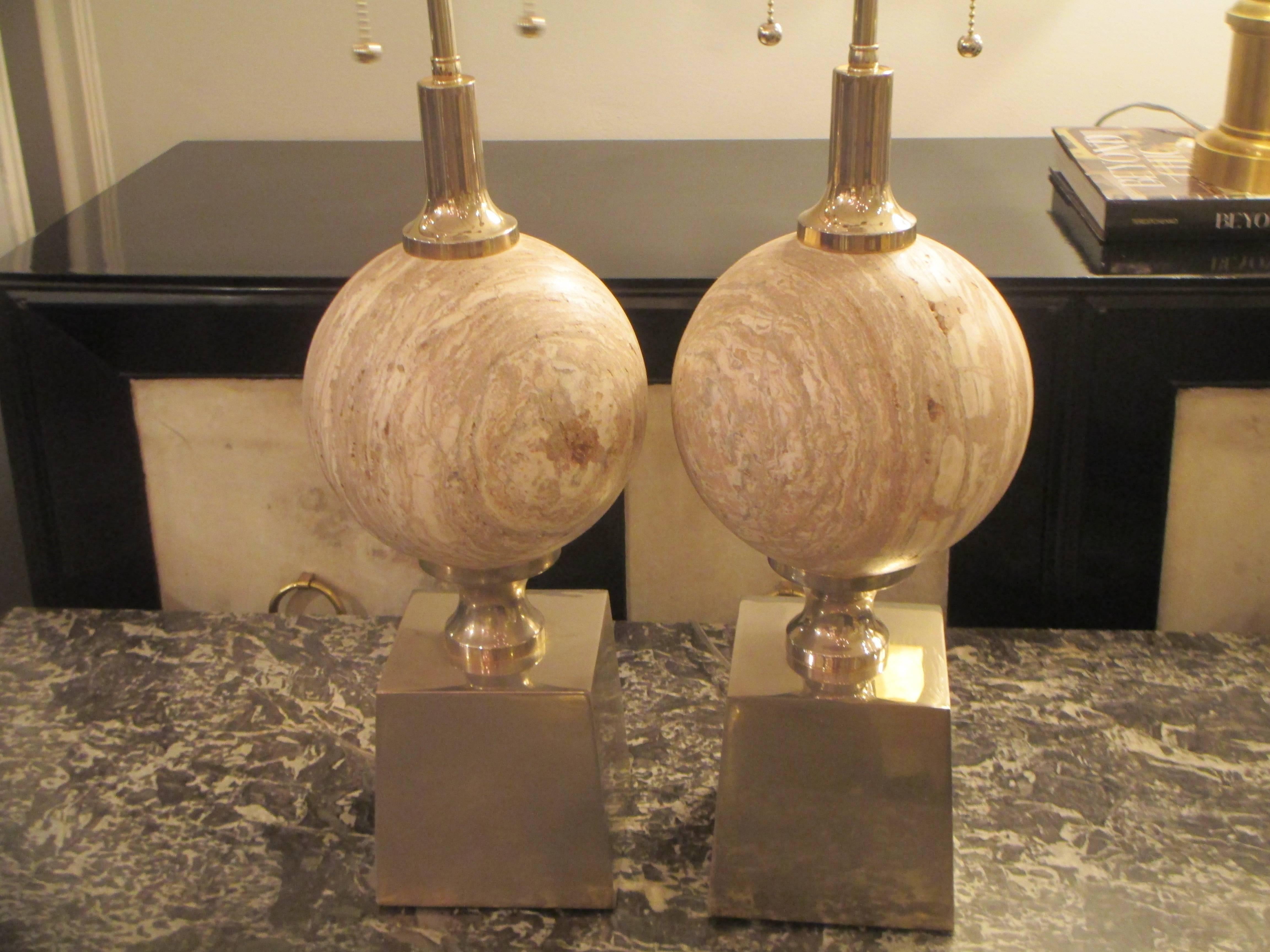 A sculptural pair of travertine lamps on chrome-plated plinth bases.