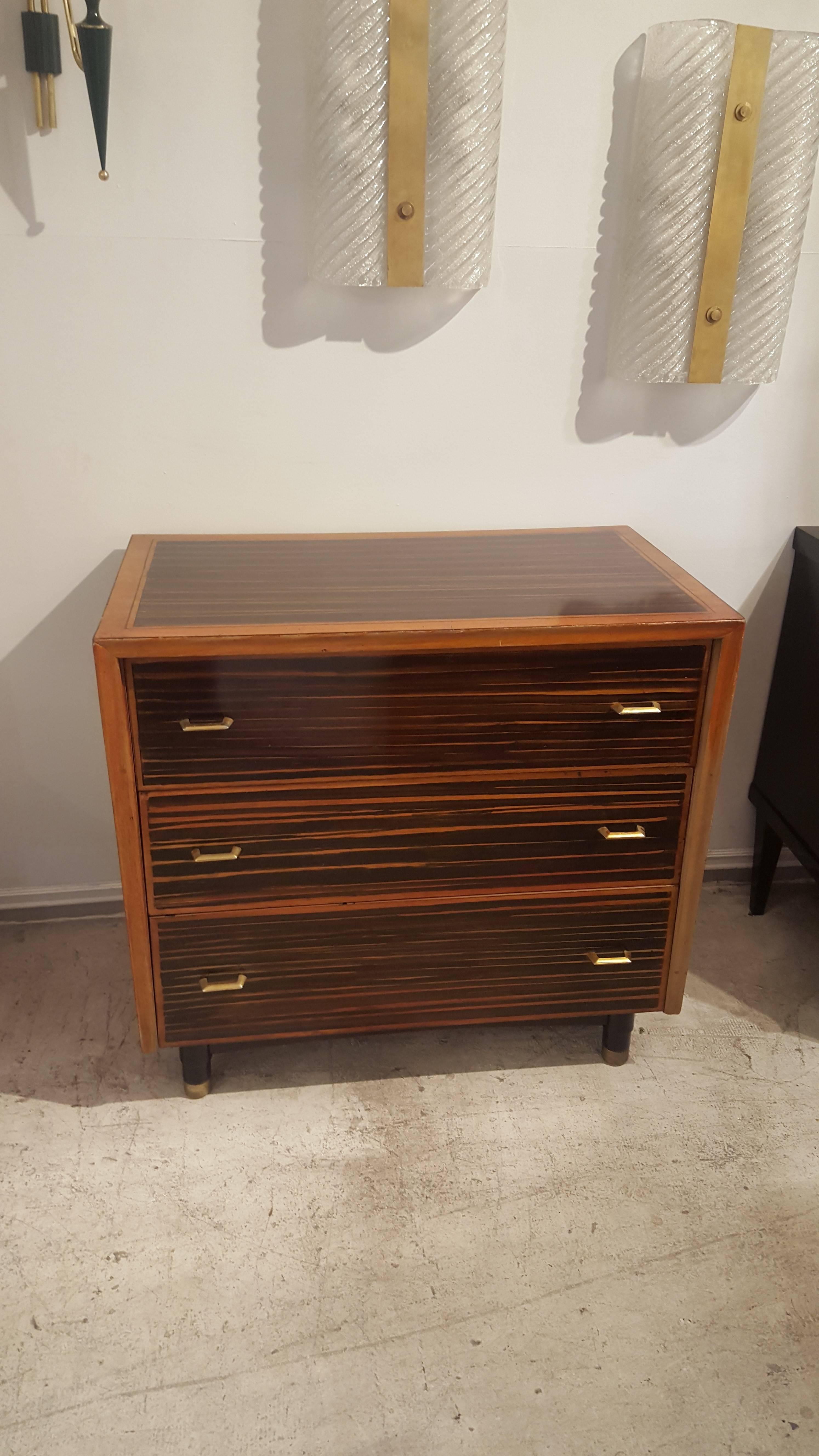 Pair of faux-painted Macassar ebony commodes with three pull-out drawers and original brass pulls.