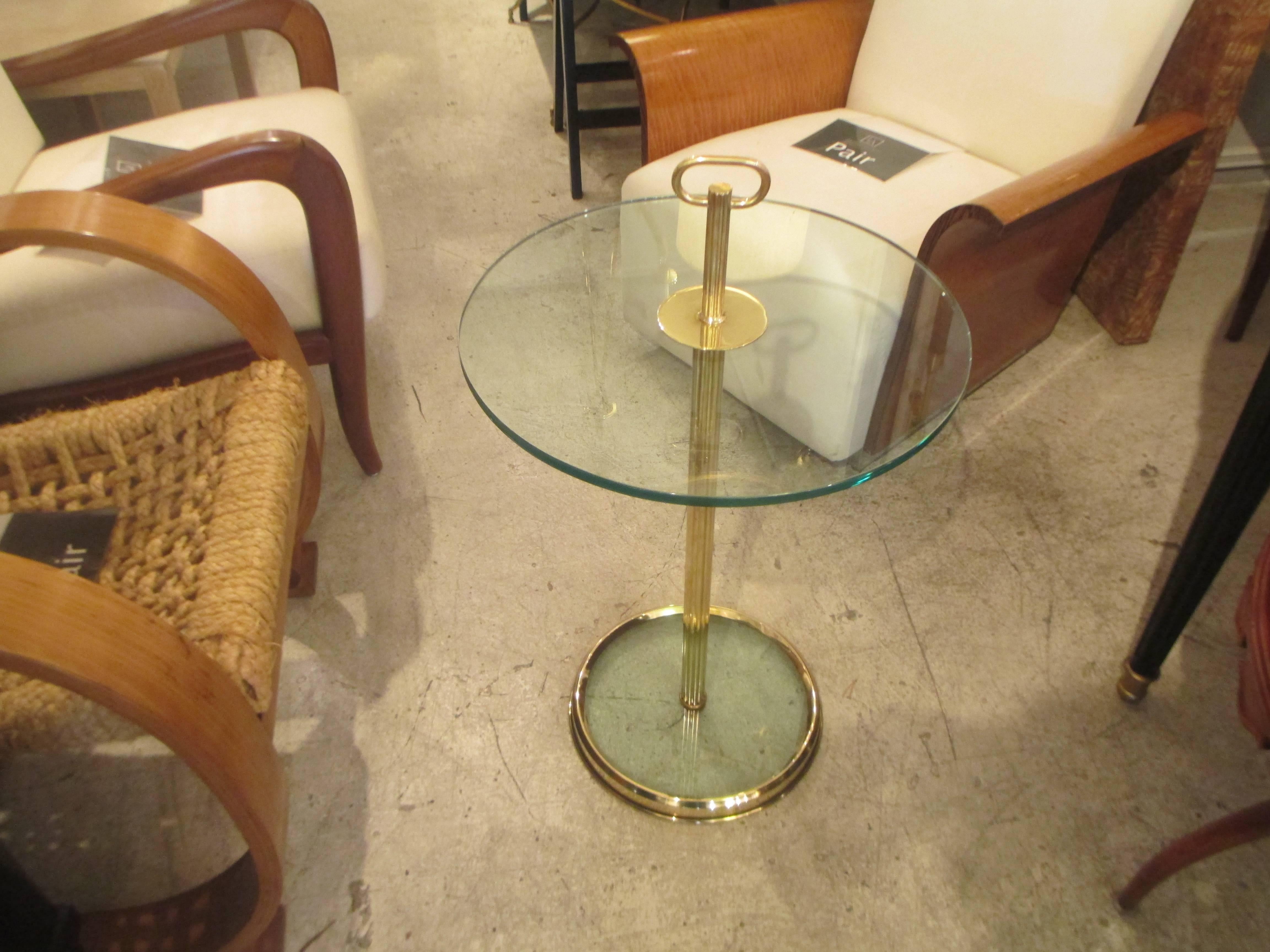 A very chic pair of modern bronze and glass tables with reeded central bronze column ending on glass and bronze circular base.