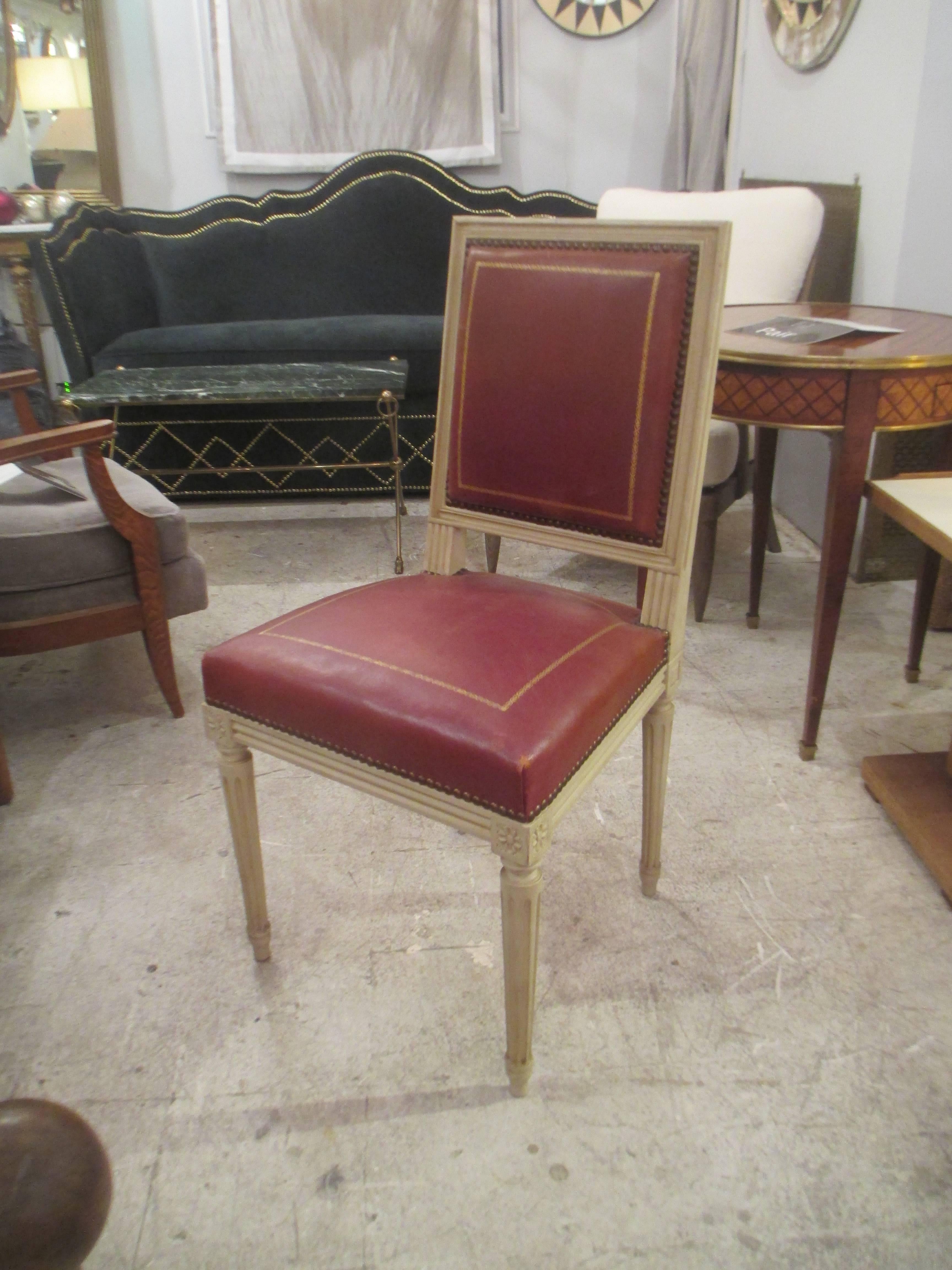 Pair of  Louis XVI style leather-upholstered chairs, attributed to Maison Jansen.