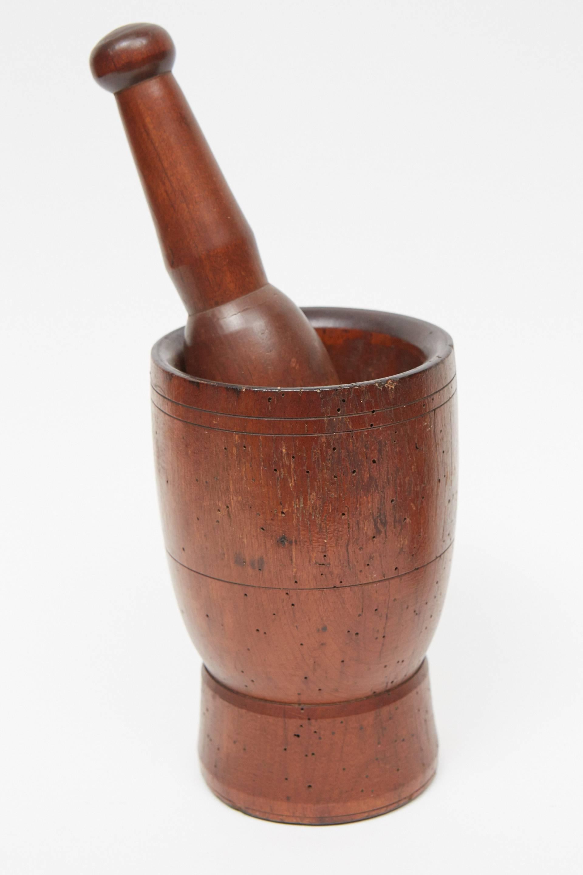 These antique turned hardwood mortar and pestles are in great condition with a beautiful patina and evidence of excellent workmanship. The three shapes and size making them a good group for a variety of settings. Made of turned fruitwood and