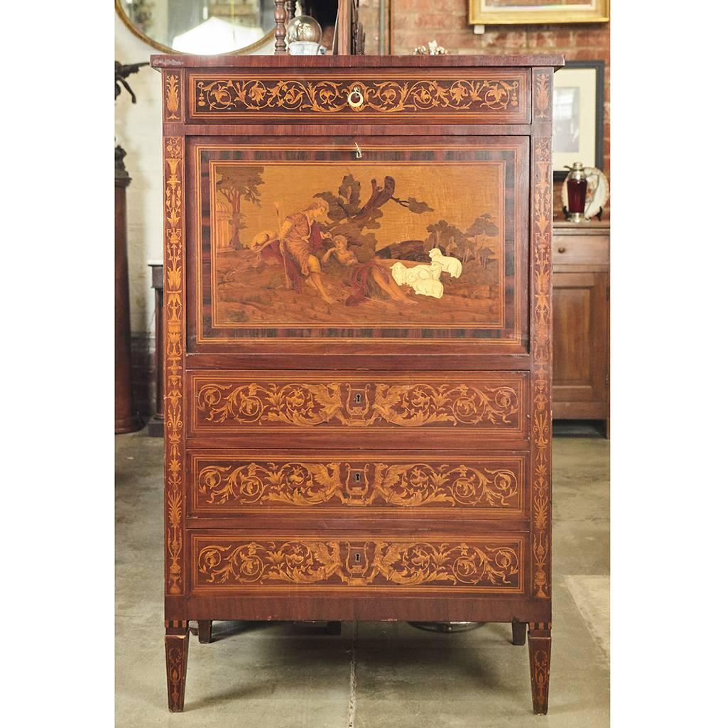 This beautiful Italian cabinet from the 1920s is done in an earlier style with intricate marquetry on all three sides. The piece has four drawers and a fall front that reveals a mirrored bar with a shelf. The marquetry has a pastoral theme with a