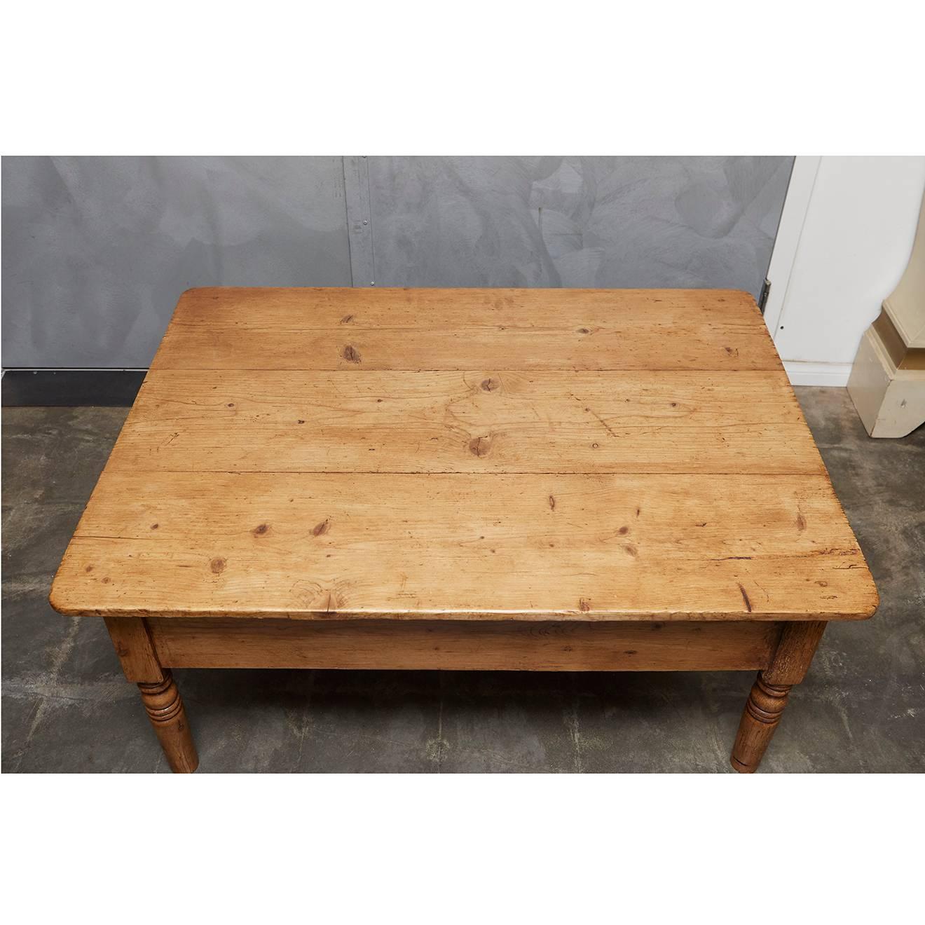 This English pine table was formerly a full height table and was converted to a coffee table over the years. It has one drawer with a large ceramic knob. The piece has a skirt and four turned legs. 







           