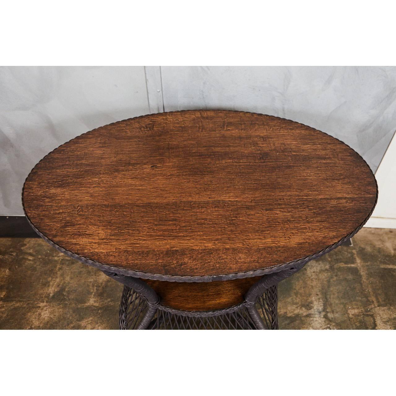 This 1930s table has an oval oak top and bentwood construction. The piece has been recently painted with farrow and ball brand paint in an ash brown color. The table has original brass tips on the feet.



 