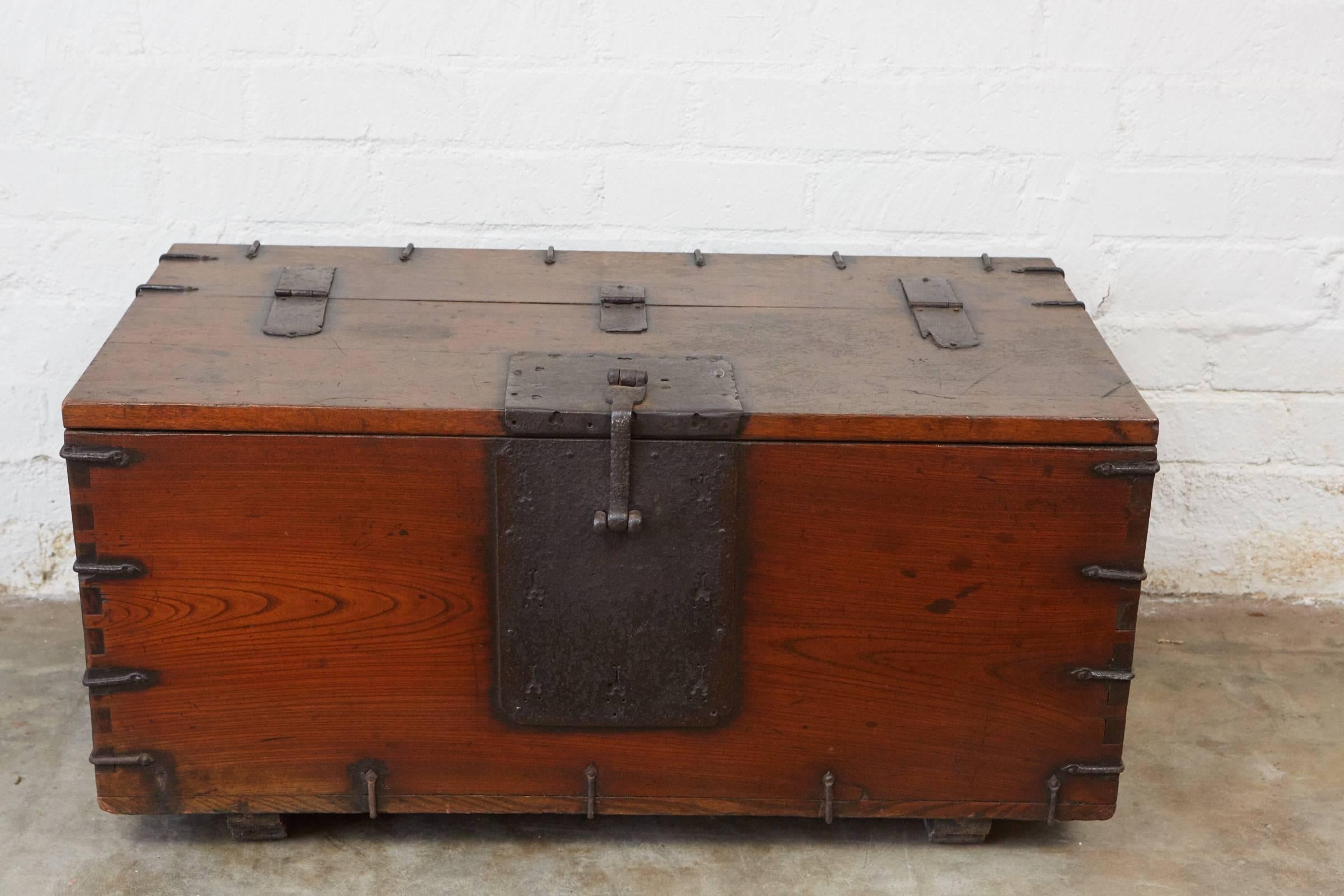 This impressive early 19th century Japanese trunk is made of Kiri wood with hand-forged iron fittings, hinges, handles and lock. The trunk sits on two wooden runners.