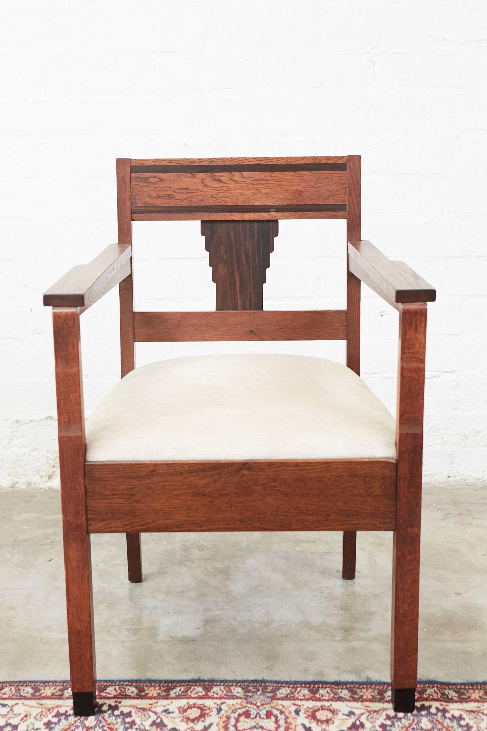 These chairs are made in oak with walnut inlay and a back panel. They have the characteristically geometric style of the furniture made as part of the Amsterdam School movement in the Netherlands (1910-1930).
       