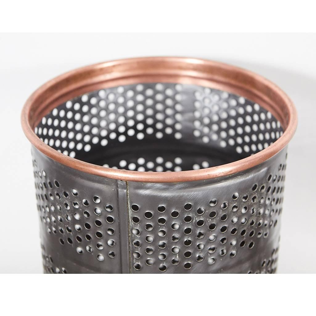 This metal wastebasket has been stripped of its original paint to reveal three different metals. It has a copper rim, stainless steel canister and an inset brass bottom. We love the look of this piece and hope you do as well.