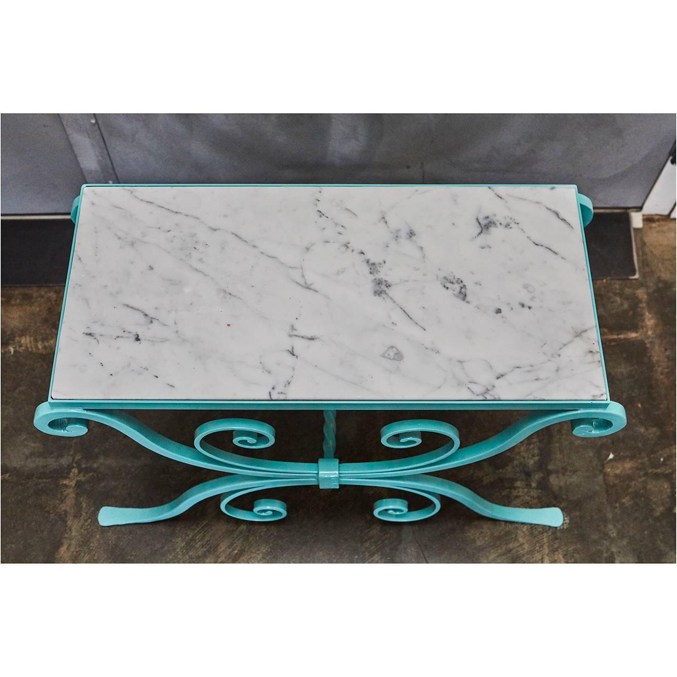 The wrought iron base of this garden table has been powder coated in a nice bright turquoise color. The small table has a newly cut marble top.


