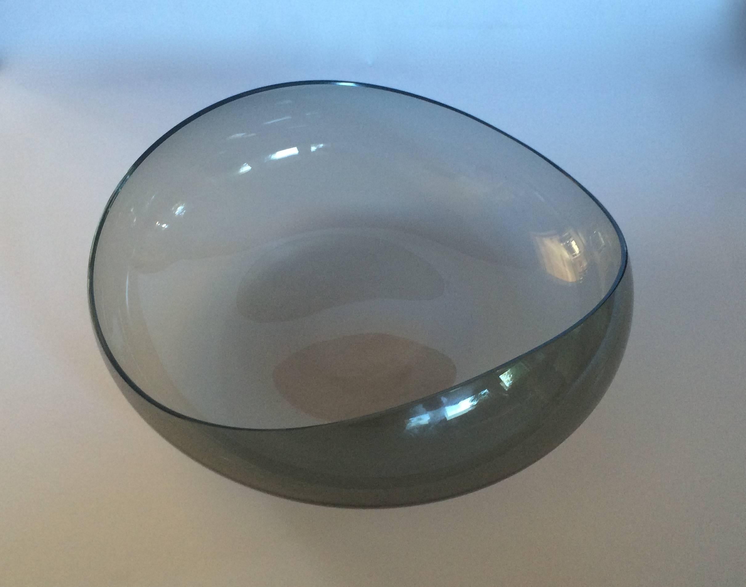 Wilhelm Wagenfeld (attributed)
Curved bowl
Circa 1950s-60s
blown smoke glass
14.5 inches in diameter

Wilhelm Wagenfeld (1900-1990) was a disciple of the Bauhaus who went on to have a celebrated career as an industrial designer in Germany. He