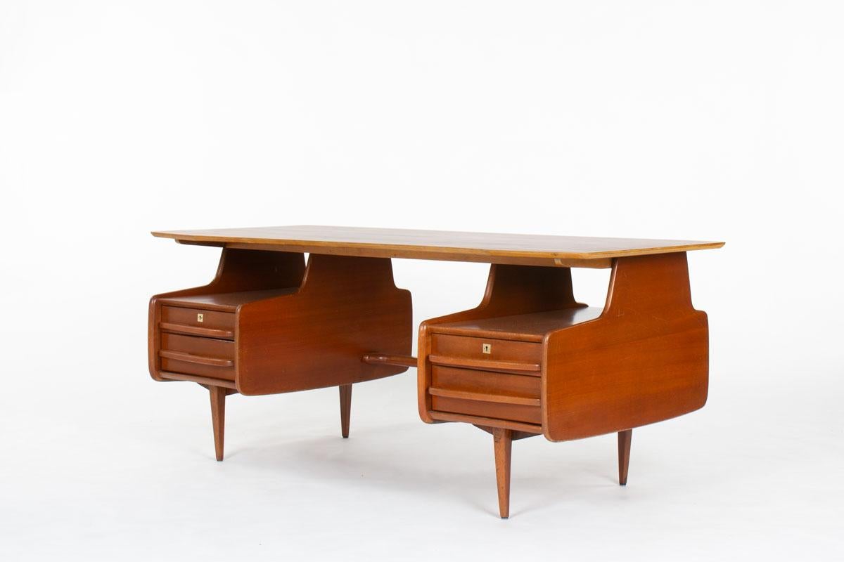 Elevate your interior with this exquisite mahogany desk by Jacques Hauville, designed in the 1950s and produced by the renowned French editor Bema. A rare example of post-war French modernism, this piece combines timeless elegance with expert