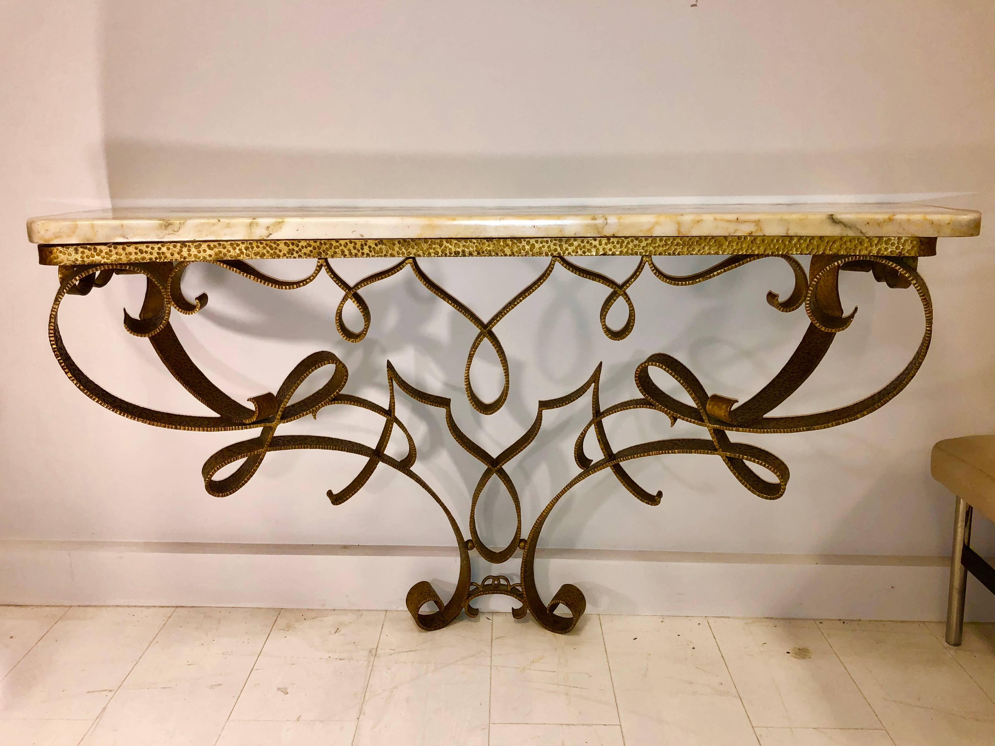 Hand-chaised and gilded ironwork in a flamboyantly elegant ribbon design, with breche Violette marble-top.