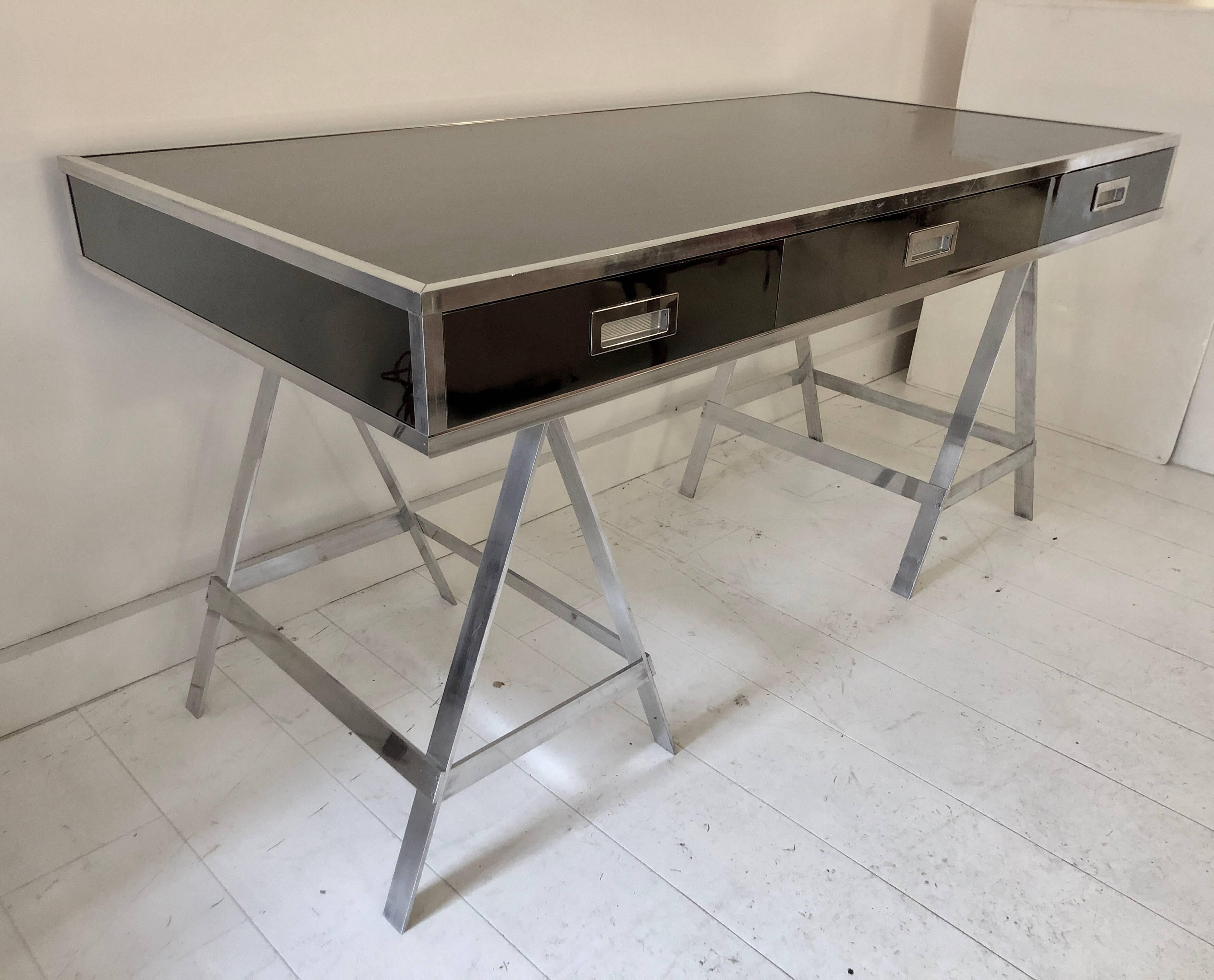 Example of the Classic Albrizzi trestle desk in polished aluminium and mirrored chrome finish, circa 1970. Three dovetailed drawers with inset pulls raised on sawhorse legs. Unsigned.