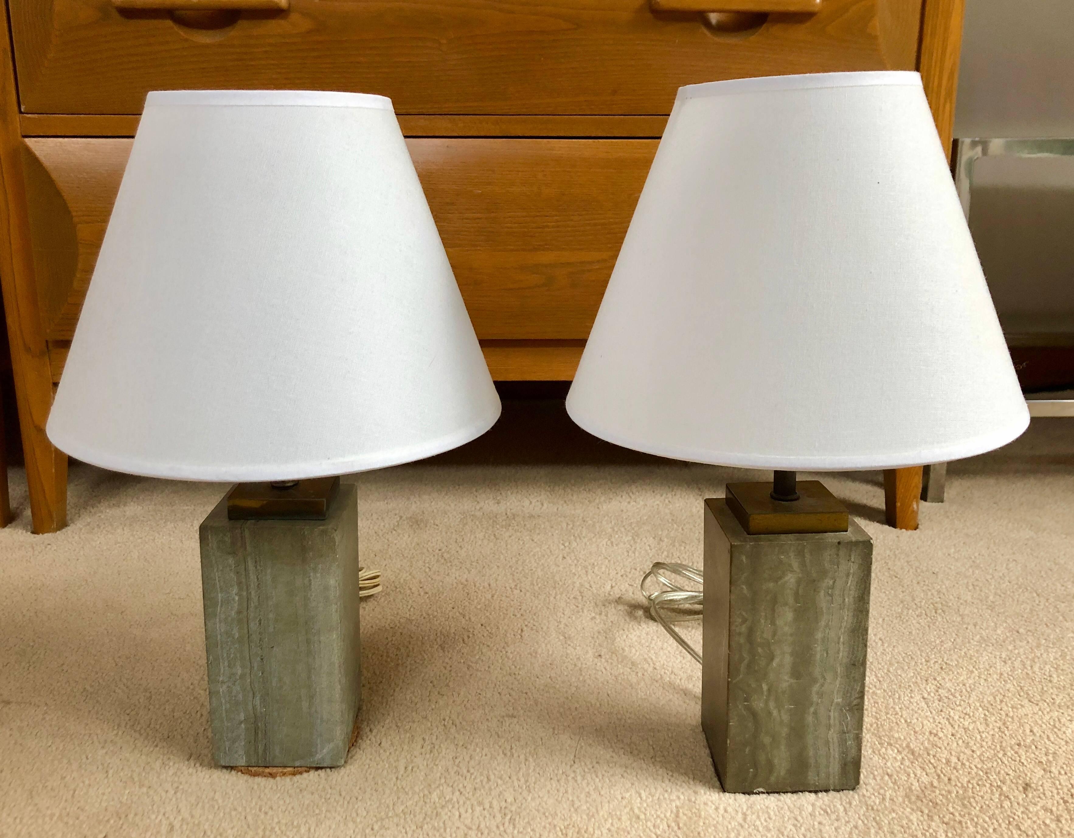 Pair of small slate grey marble table or bedside lamps with brass fittings. Measures: Marble height is 6.5 inches.