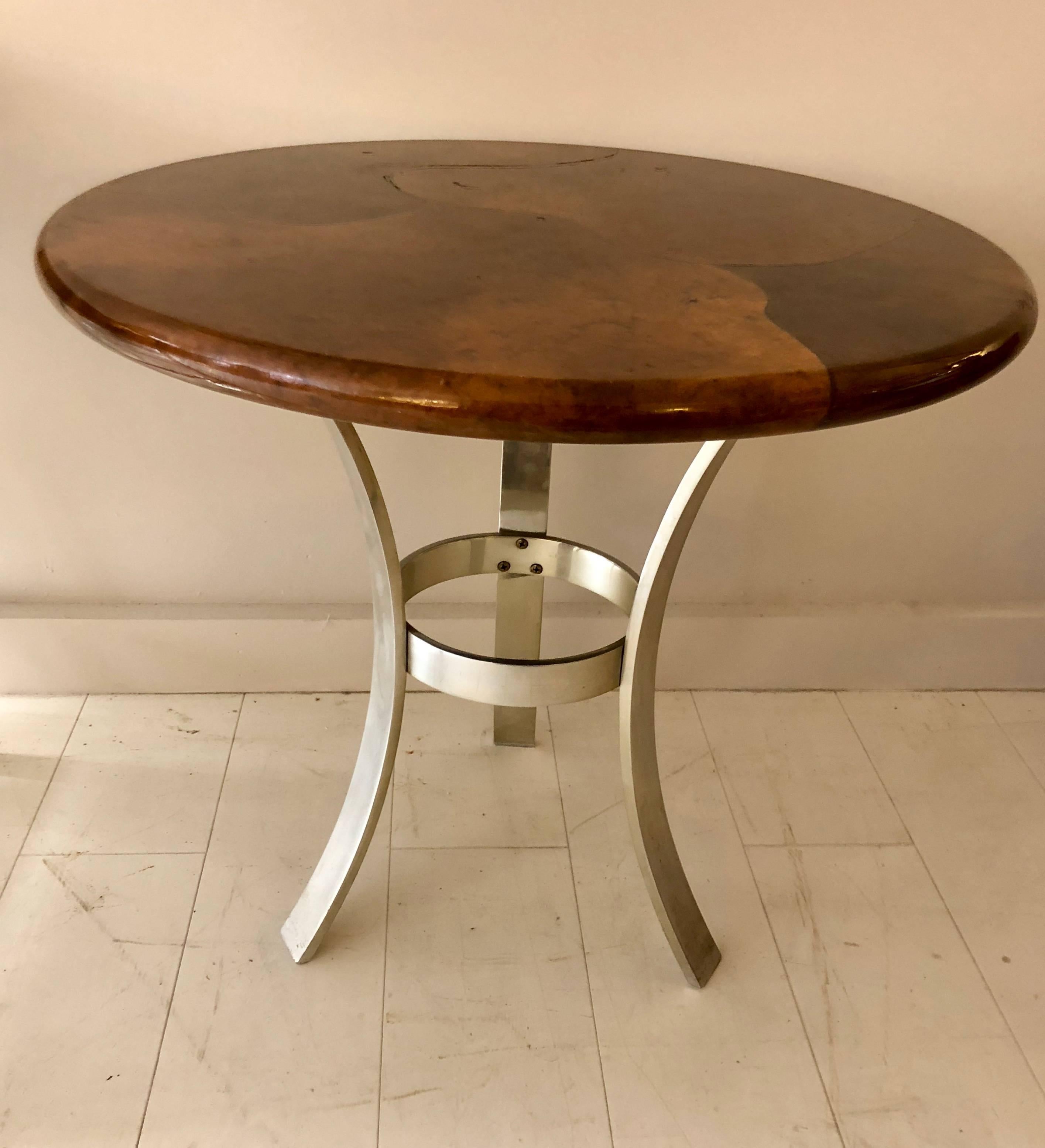 High quality 1970-1980s era table with brown parchment clad top on modernist tripod base. The form is after a John Vesey design and may be a later Paul M. Jones interpretation. Unsigned.