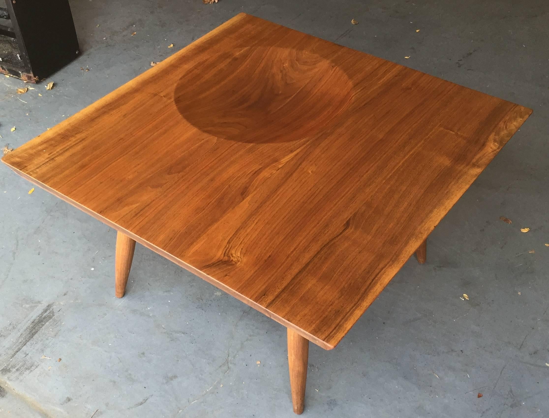 Wonderful 3' solid walnut top table. Expertly hand-carved, with sharply beveled edge and perfectly round bowl-shaped divet and dramatically tapered dowel legs. Luminous wood grain was hand-finished in linseed. Unsigned but likely made by a craftsman