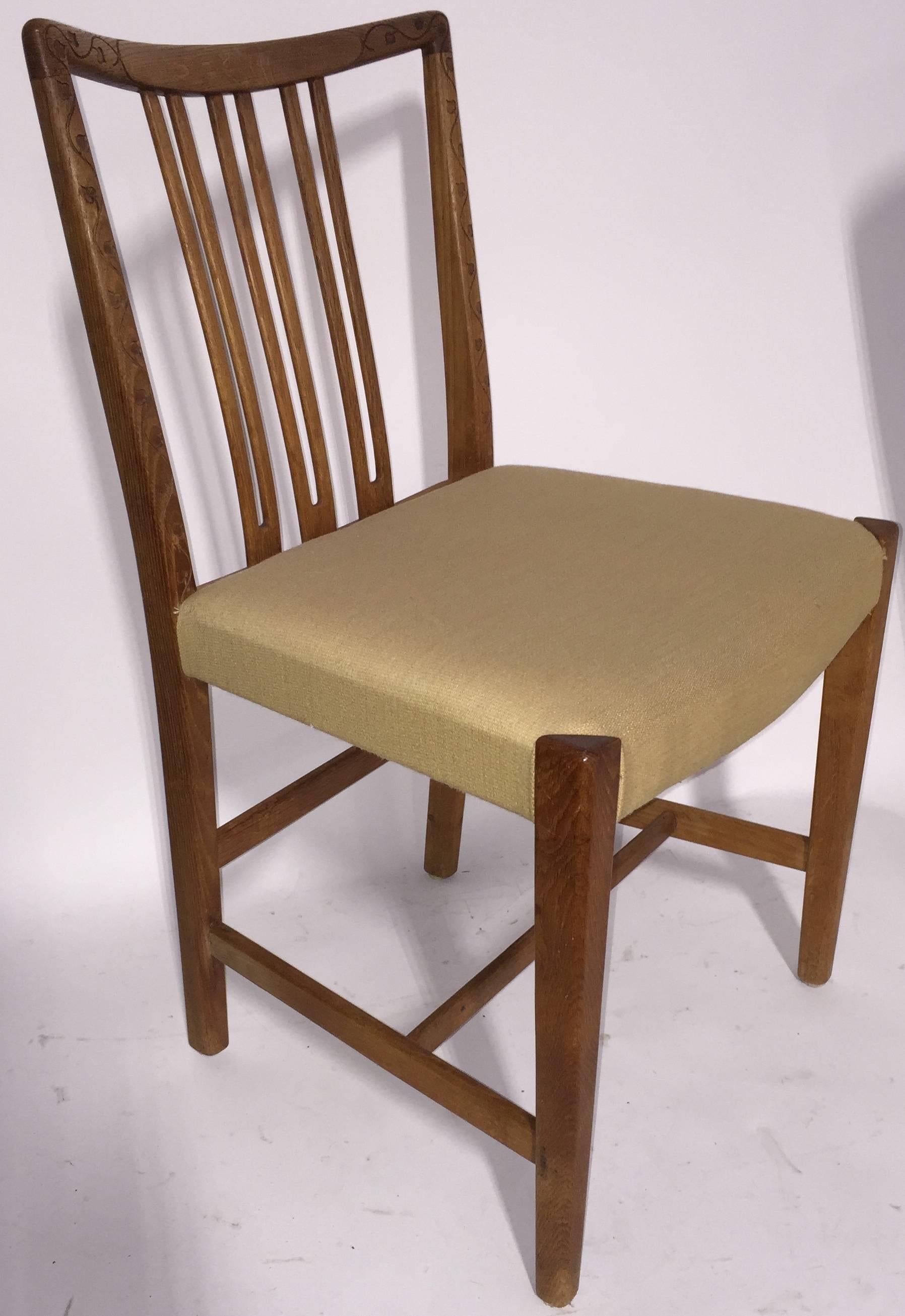 Rare early design by Hans Wegner for Mikael Laursen.  Solid Oak frame  with upholstered seat and delicate leaf and vine carving on backrest.  