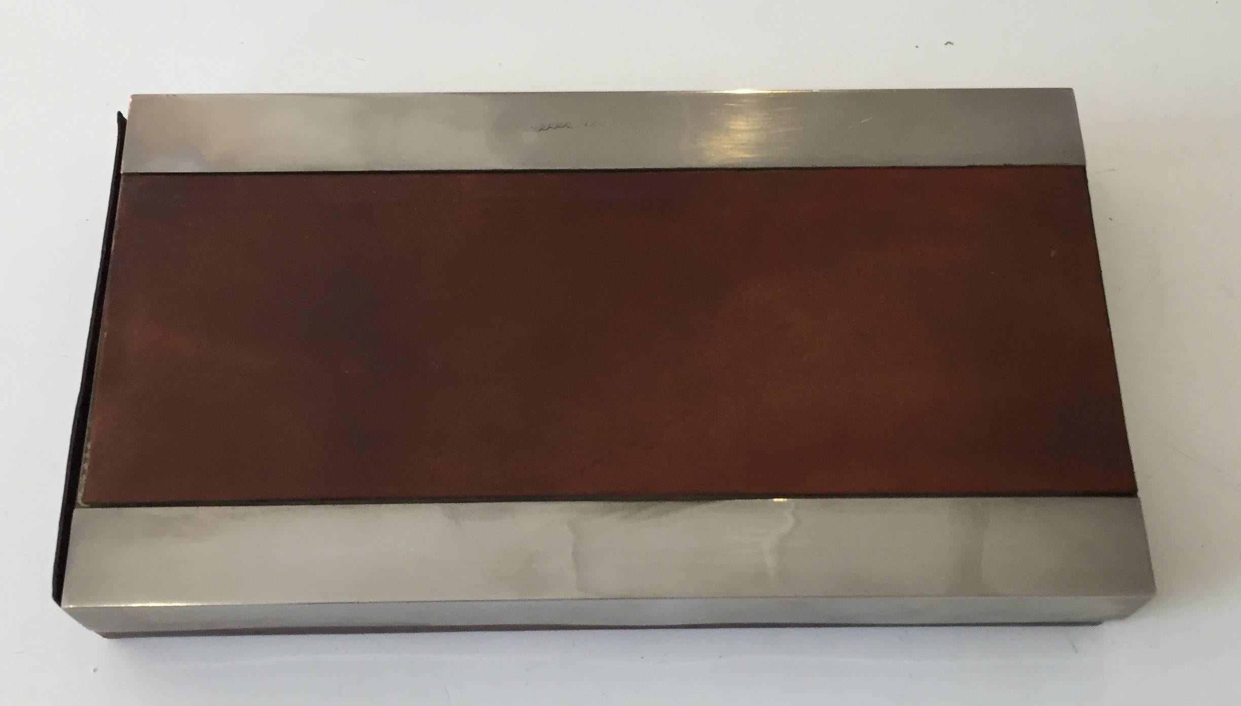 Chic leather box with steel accents. Top slides to reveal interior. Signed.