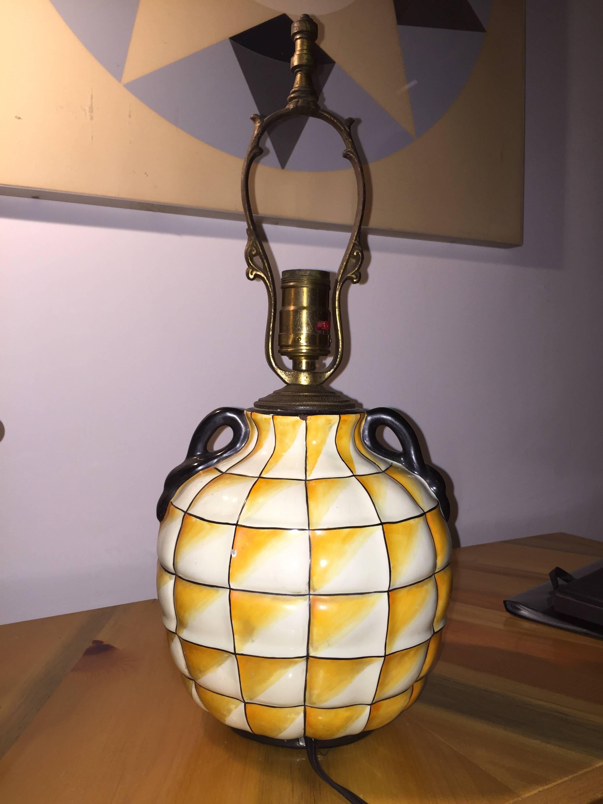 Fantastic pottery lamp with hand-painted opt-art gridded base with swan-form handles. The vase form is pictured in a 1928 issue of Art et Decor featuring Gio Ponti's designs for the Ginori factory. This example was cast as a lamp base, with molded