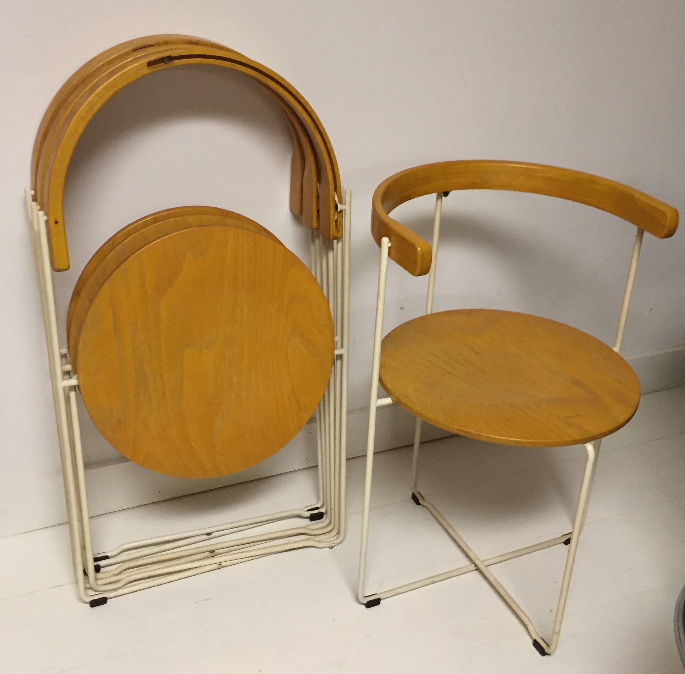 Ingeniously designed birch and enamel metal chairs store flat by open into perhaps the chicest folding chair ever. Produced by Kusch and Co. Matching birch table is also available.