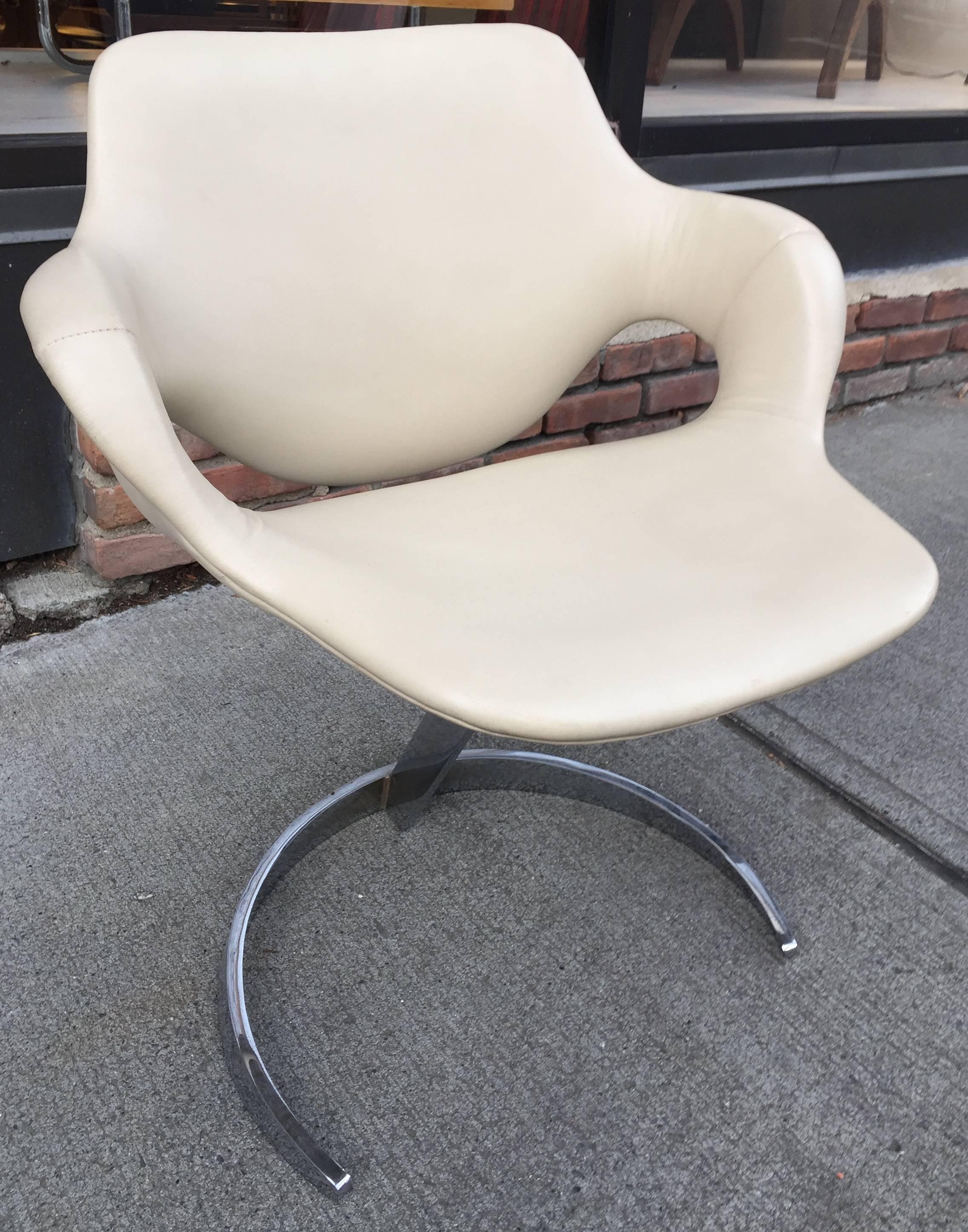 Spage age chromed steel and cream skai upholstered chair. As comfortable as it is chic.