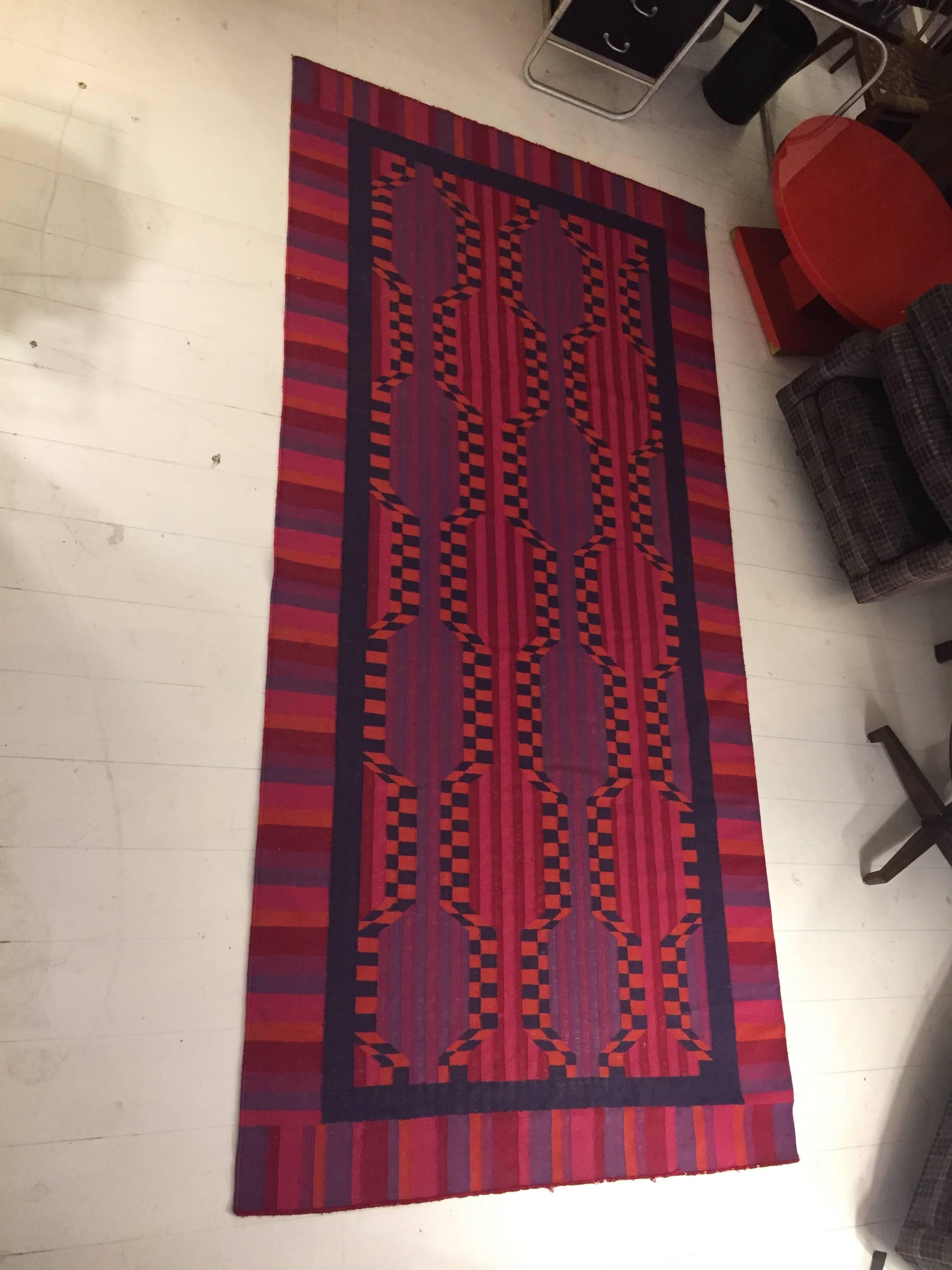 Wool area rug with op-art pattern.
