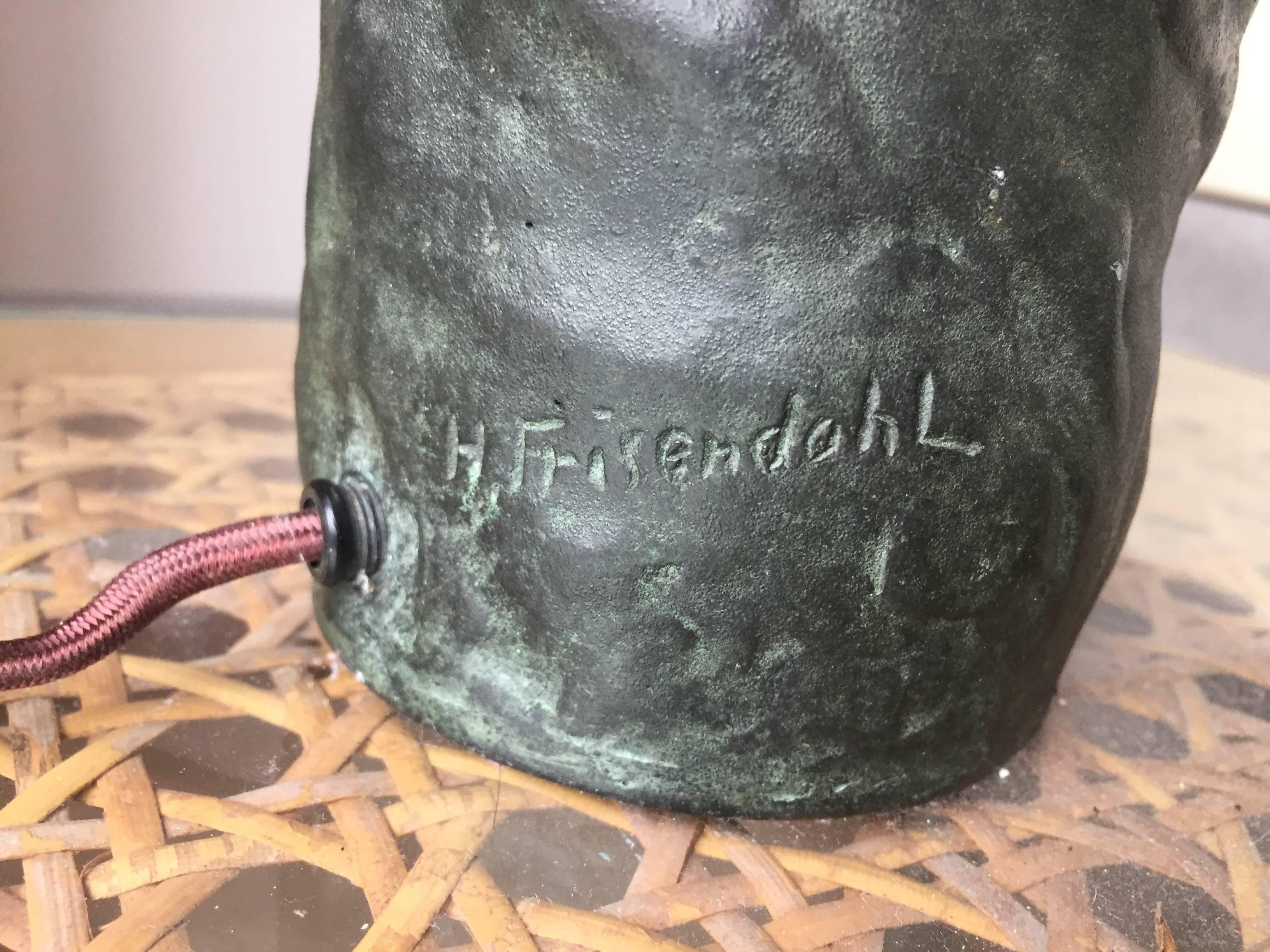 Cast bronze, patinaed lamp with abstract figural nudes in relief is both modern and timeless. Frisendahl was an important Swedish Art Nouveau sculpture. 

Signed on base. Lamp is 10