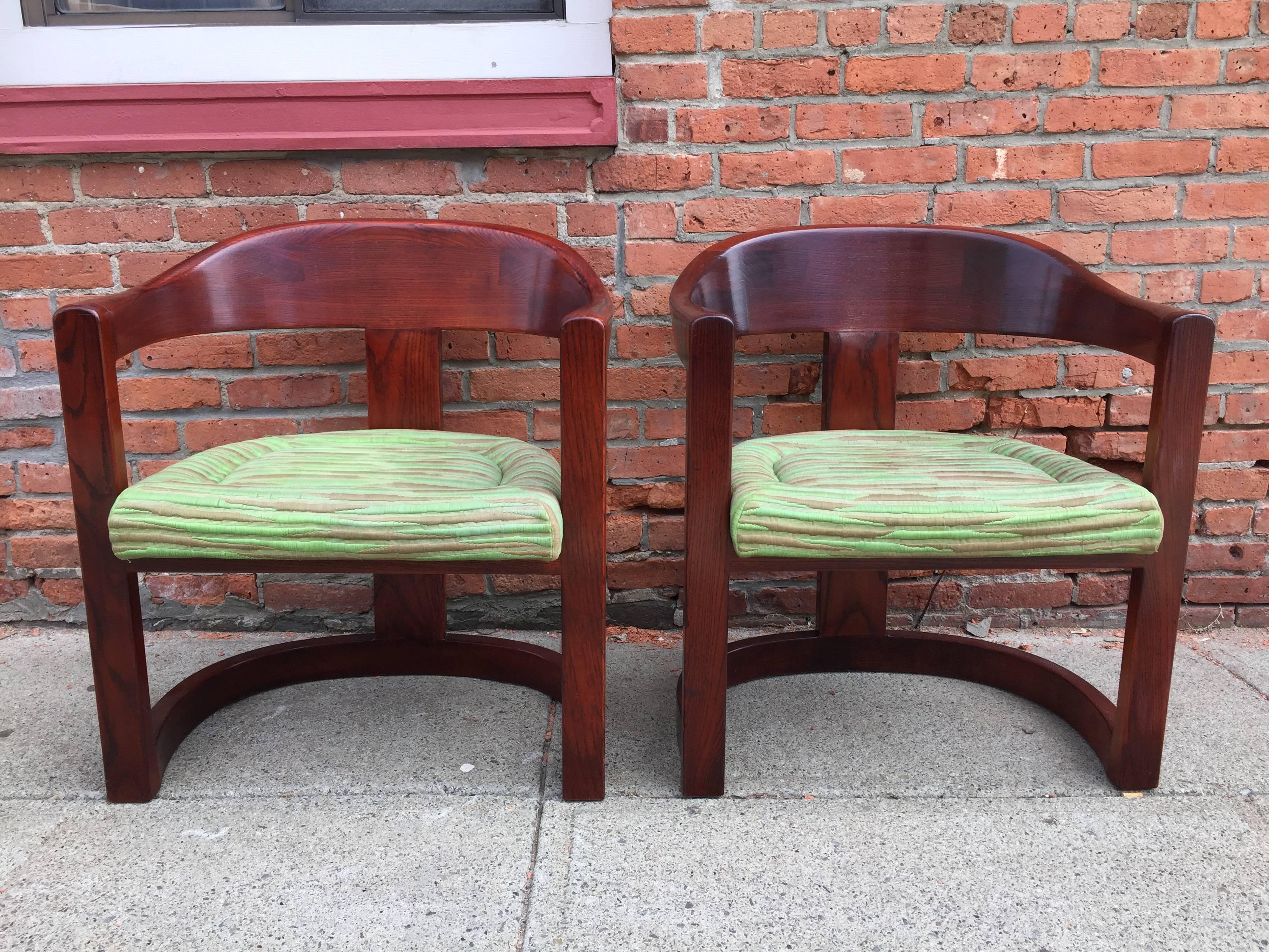 Original oxblood red mahogany stained chairs with complimentary red and green silk fabric seats. Wonderful mix of color and form.