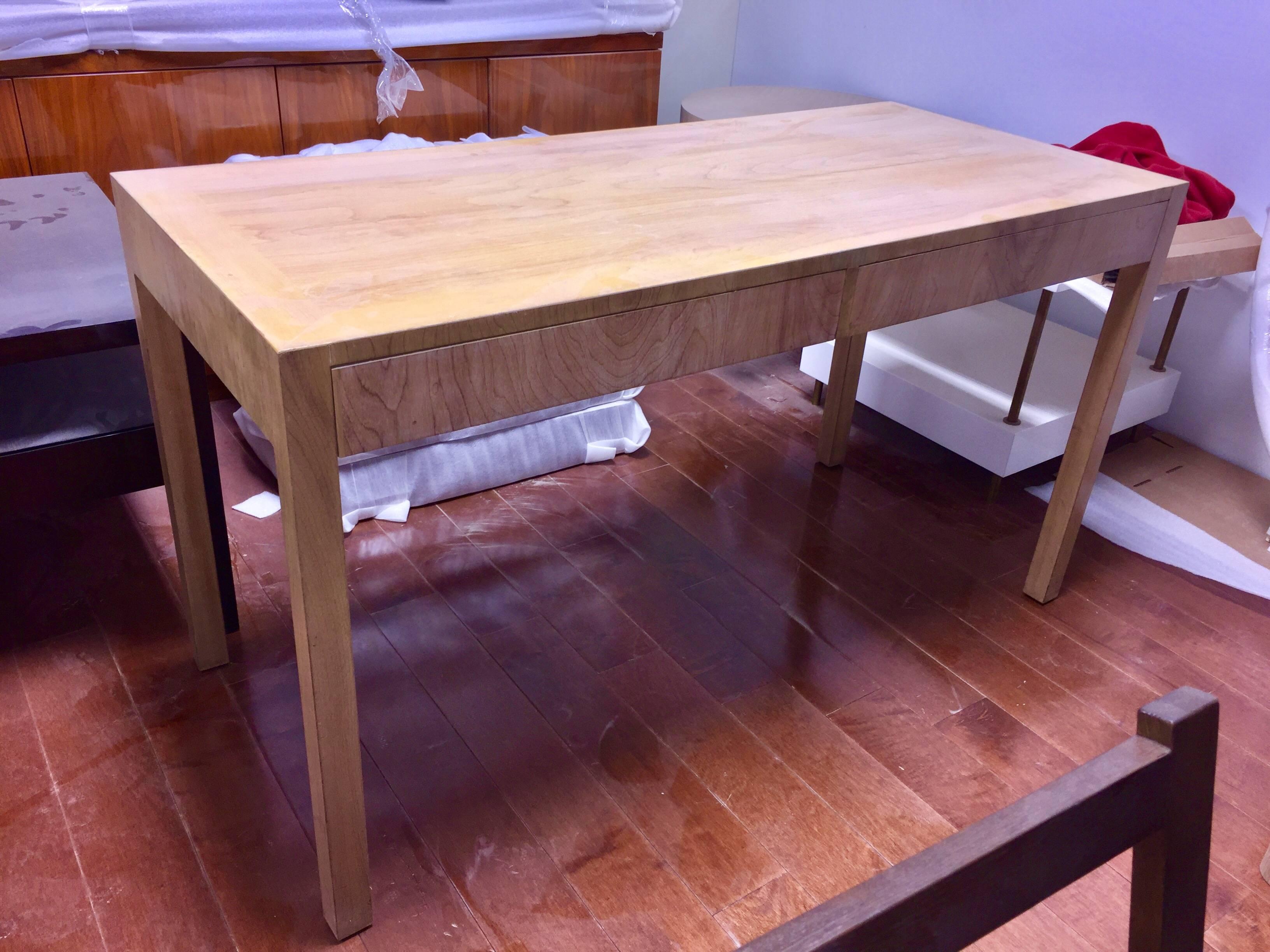 Simple modernist two-drawer Parson's desk in bleached open-grain walnut. This writing table is part of a custom designed library suite we acquired from the heirs of the family that hired Robsjohn-Gibbings in 1938 to decorate their 92nd and fifth