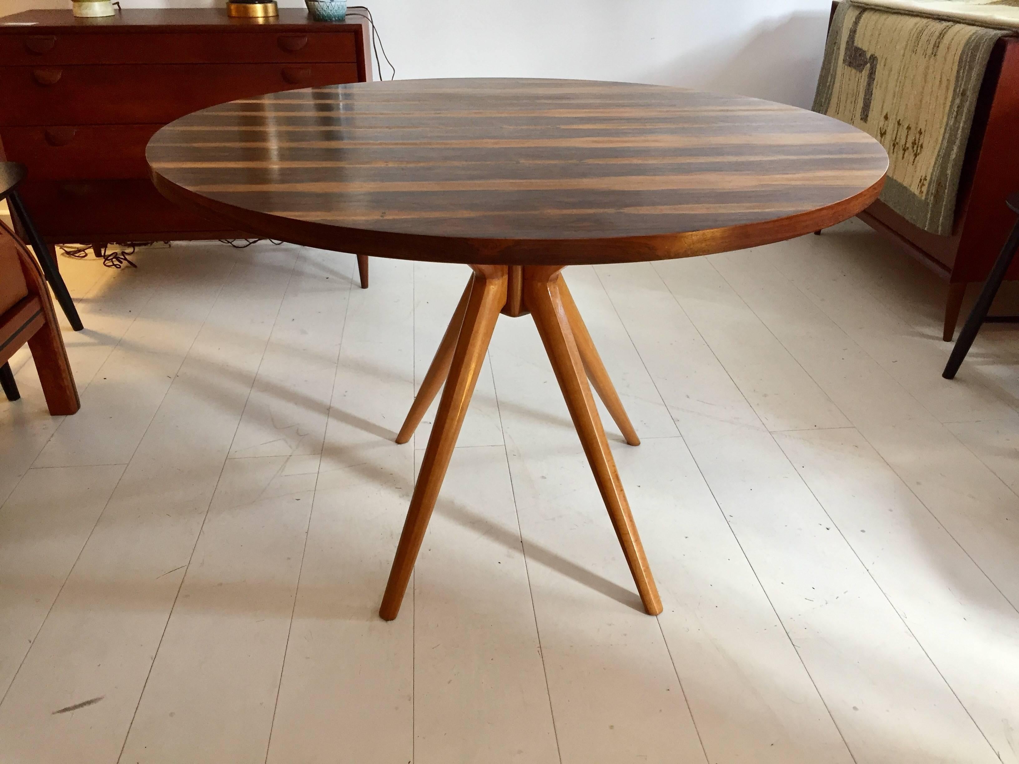 Wonderful example of Italian organic design from the early 1950s. Sculpted four-legged maple pedestal base with highly figured bookmatched rosewood top. Retains the Tecno label.